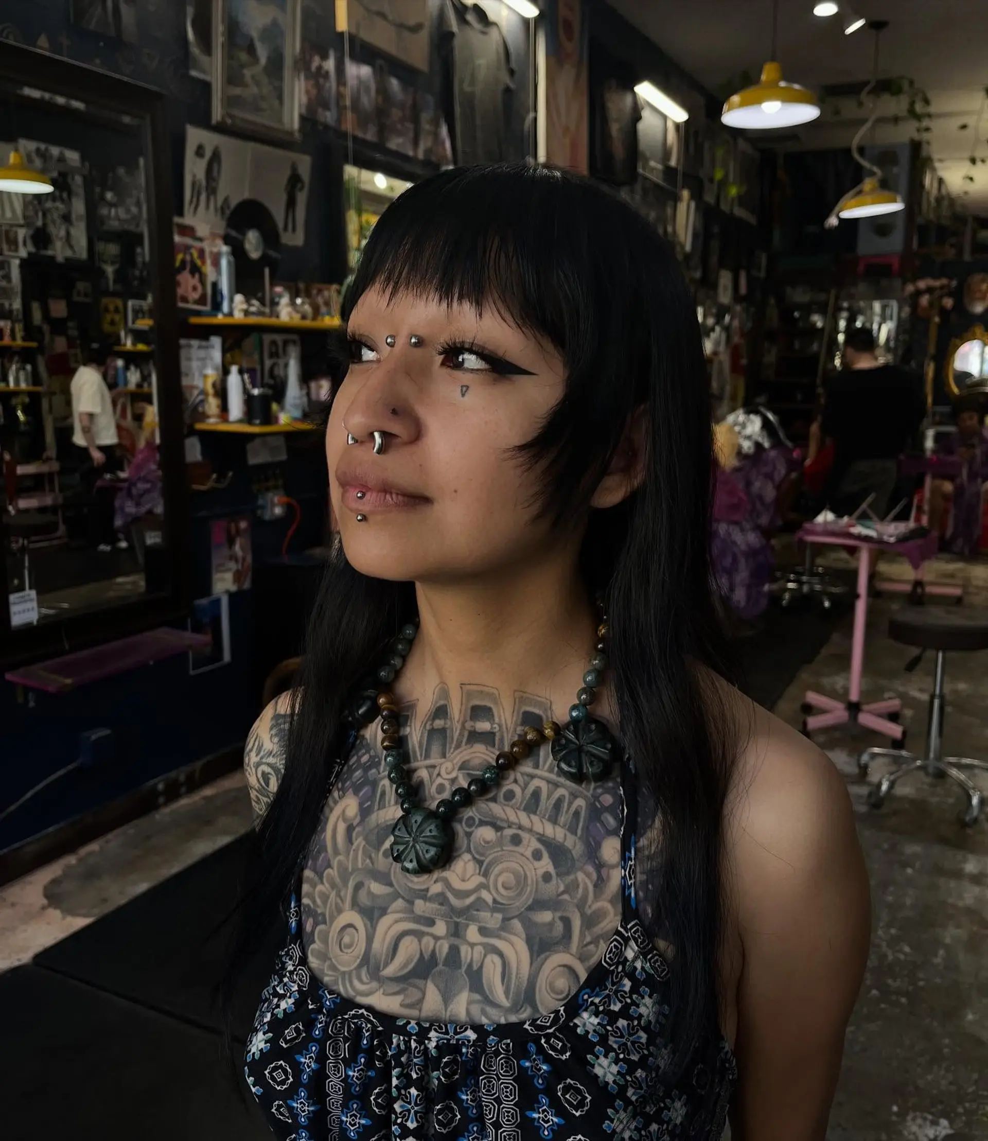 Straight black hair featuring blunt textured bangs and tapered face-framing cheek layers. 1