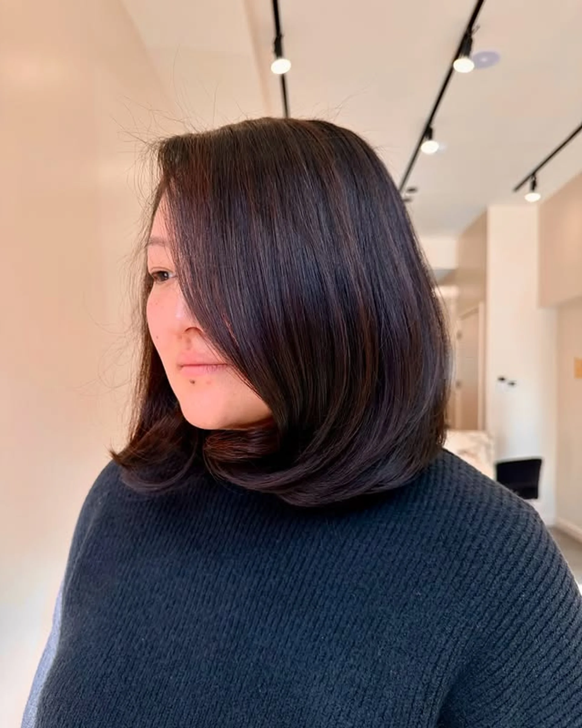 A modern, chic blunt bob with soft layering representing the polished 2026 graduate aesthetic - Preview 3