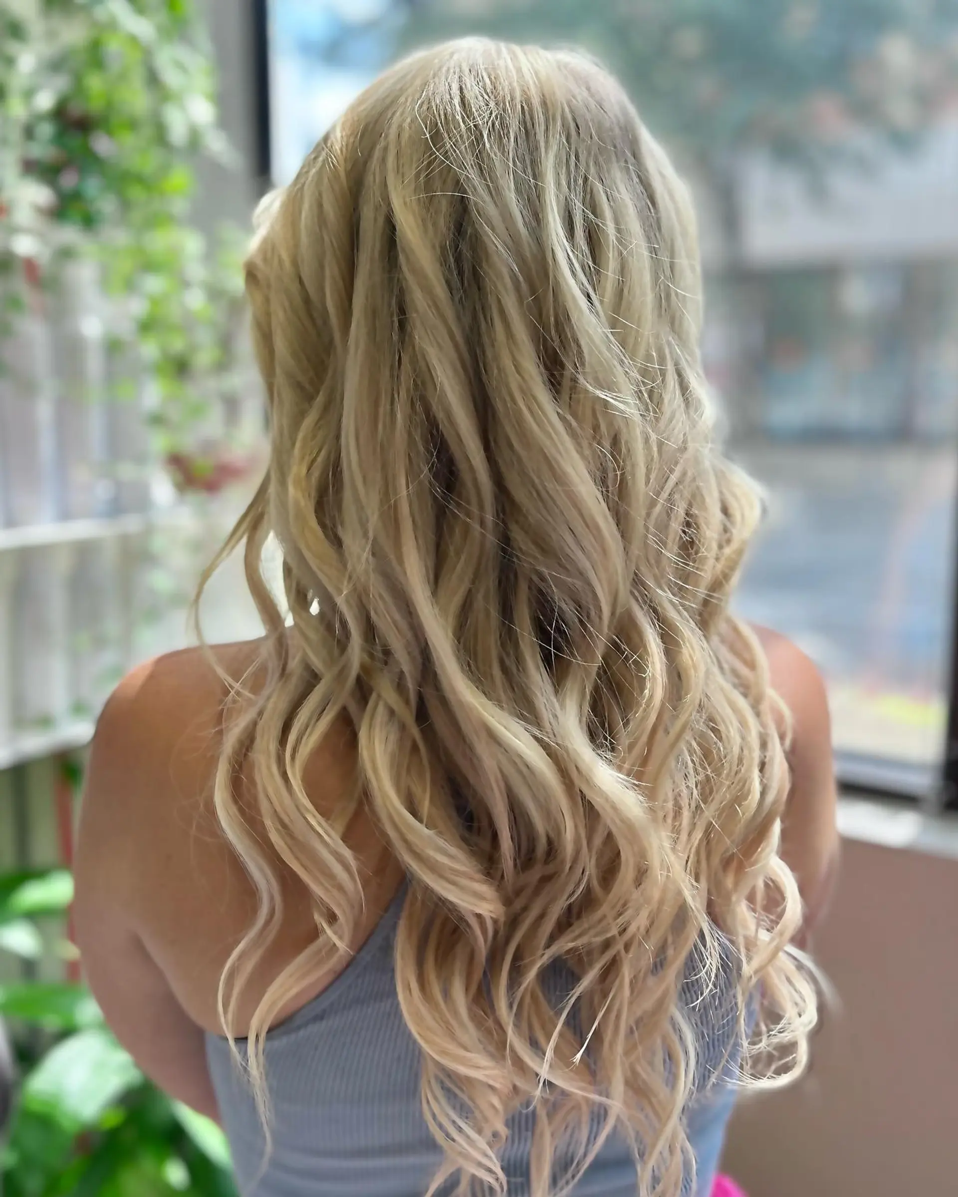 Long, wavy blonde hair with a beachy, dimensional effect. 1