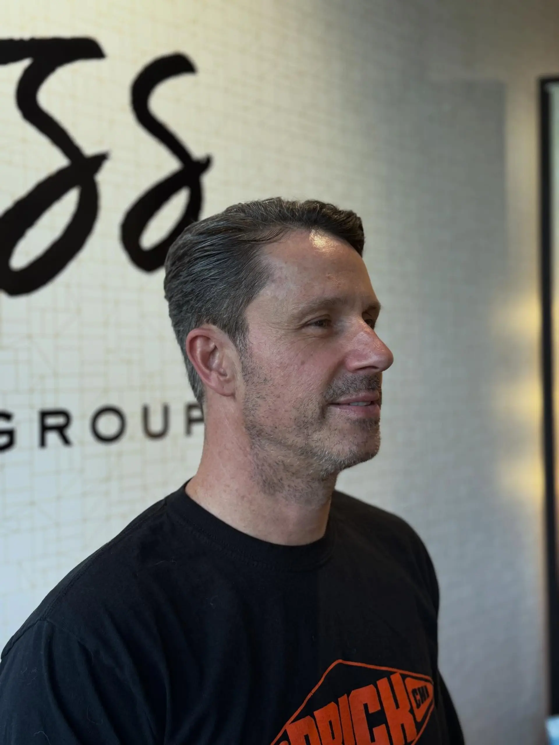 A classic men's haircut styled smoothly back with neatly tapered sides and clean edges. 1