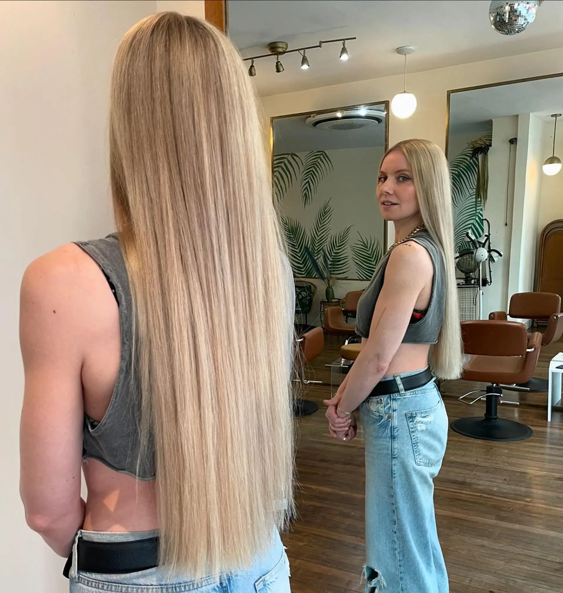 A sleek, glossy, and extraordinarily long blonde hairstyle with a natural, straight finish, emanating elegance and timeless beauty. 1