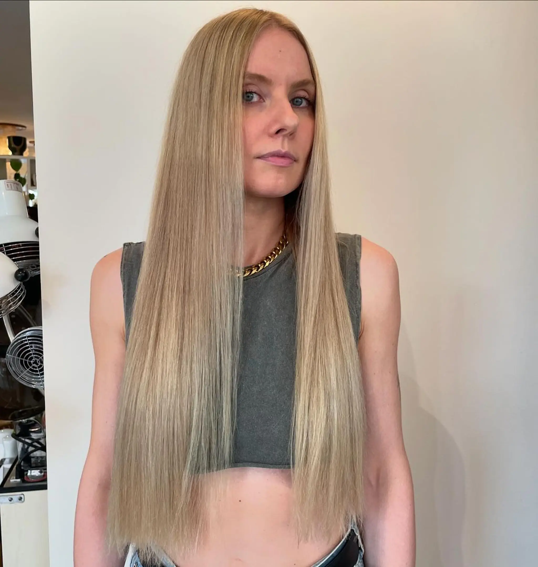 A sleek, glossy, and extraordinarily long blonde hairstyle with a natural, straight finish, emanating elegance and timeless beauty. 2