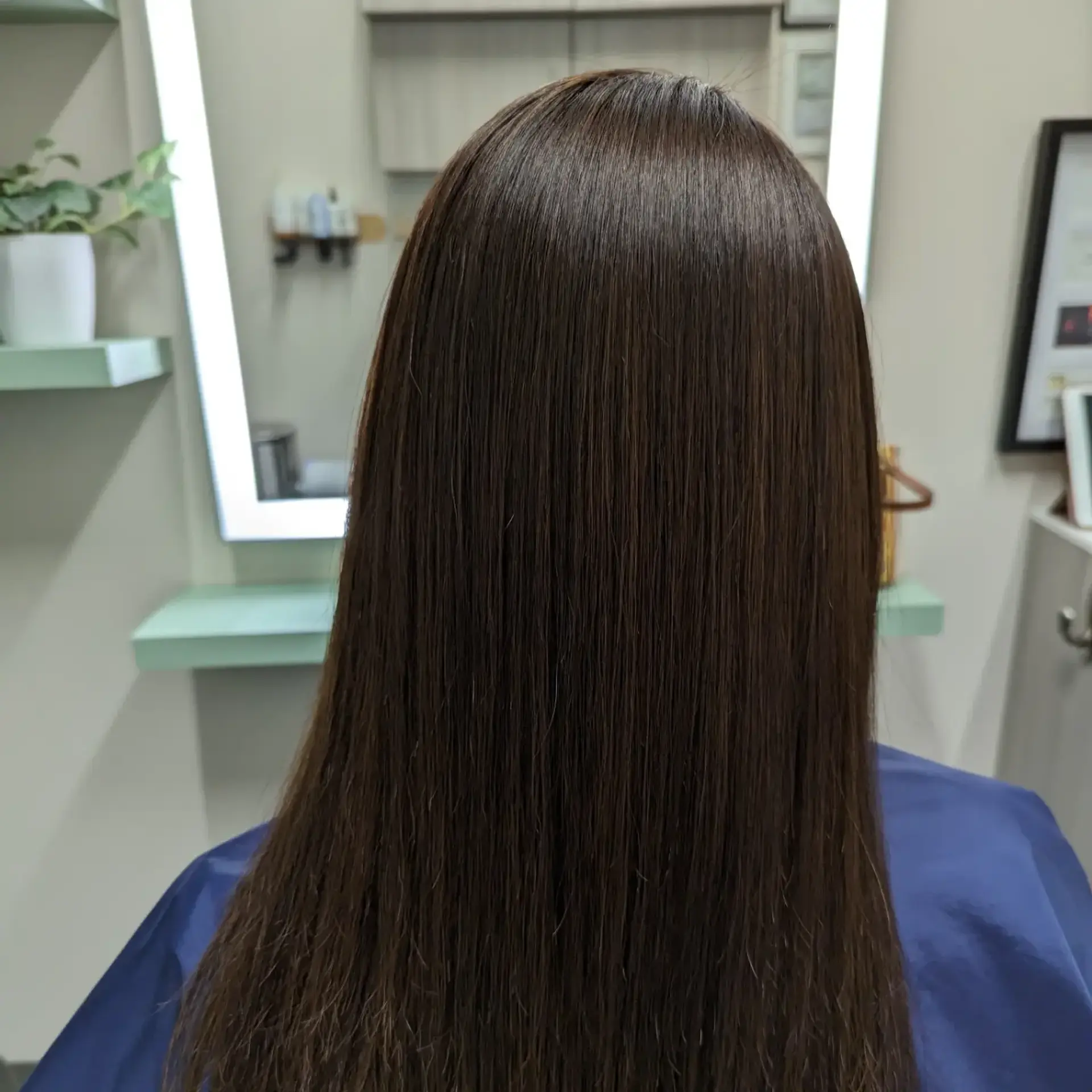 Ultra-sleek, pin-straight long dark brown hair with exceptional shine and smoothness. 1