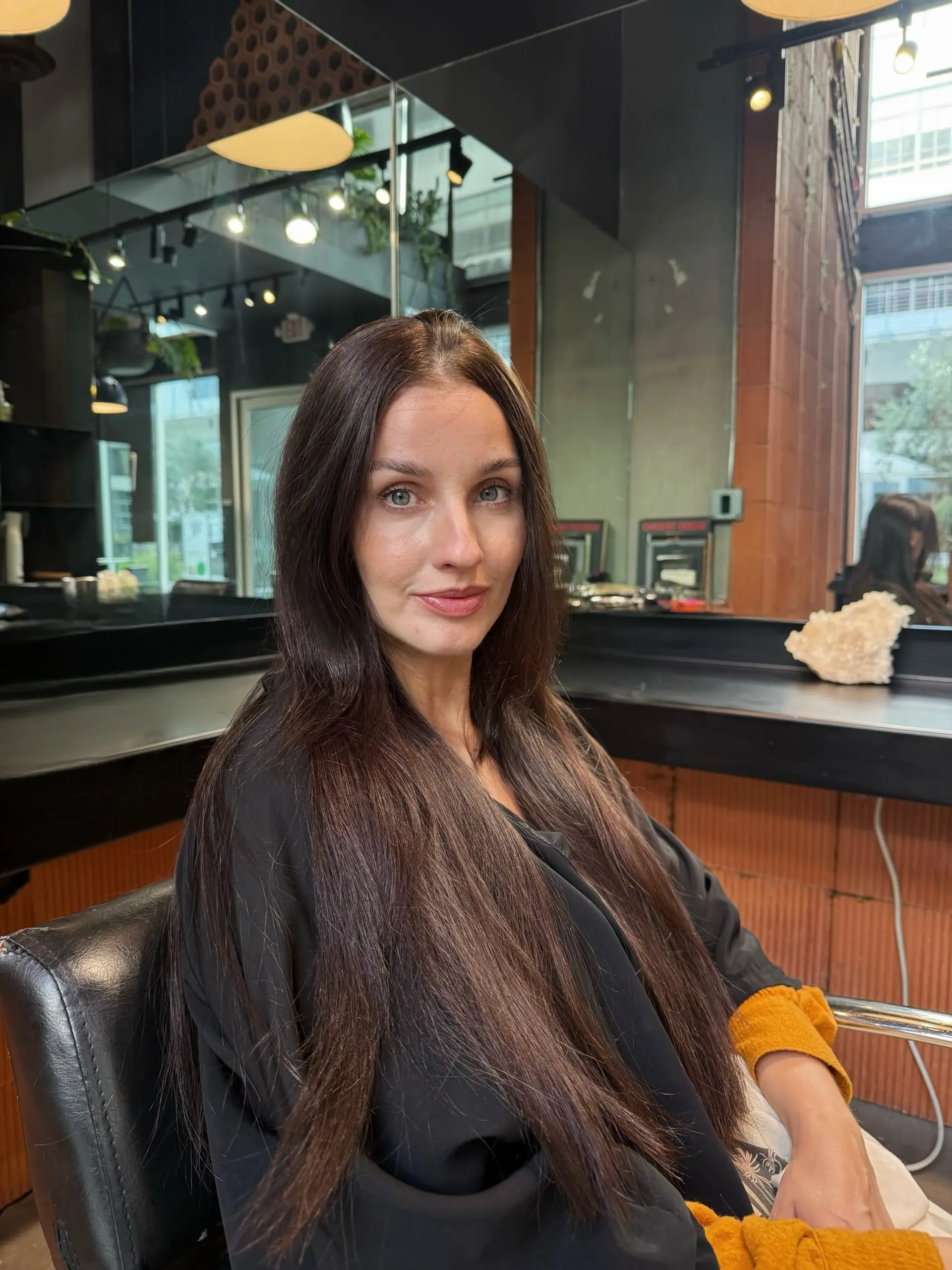 Ultra-long, smooth dark chocolate brown hair styled straight with a center part and draped over the shoulders. 1