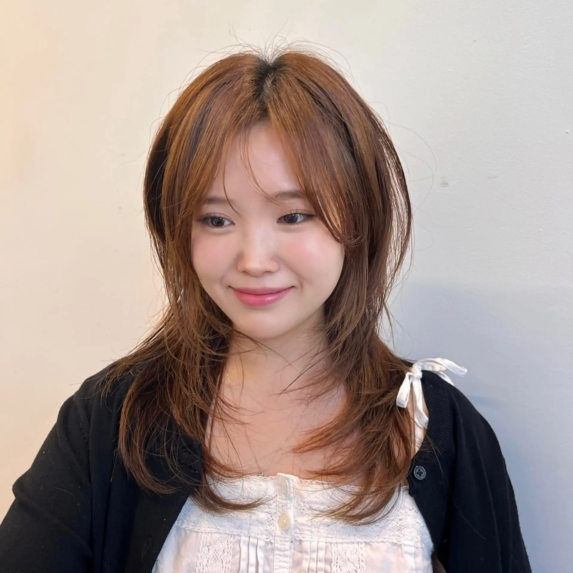 A medium-length shag haircut with curtain bangs and textured layers. 1