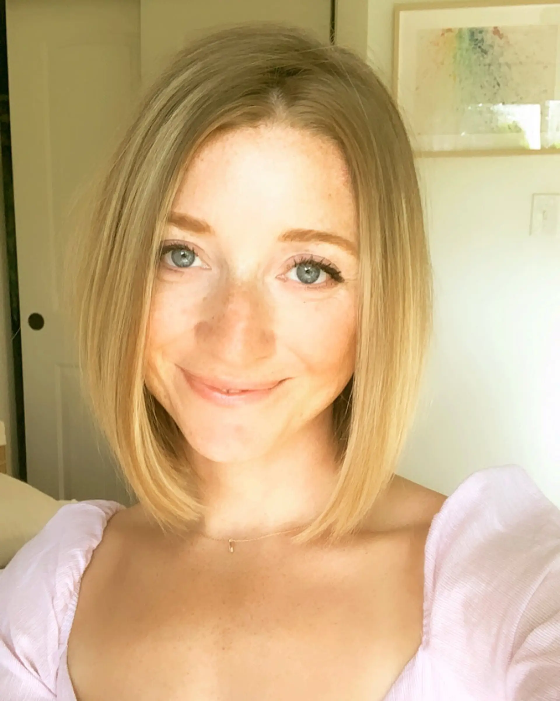 A sleek, above-the-shoulder blunt bob haircut styled straight with a subtle bevel at the ends. 1