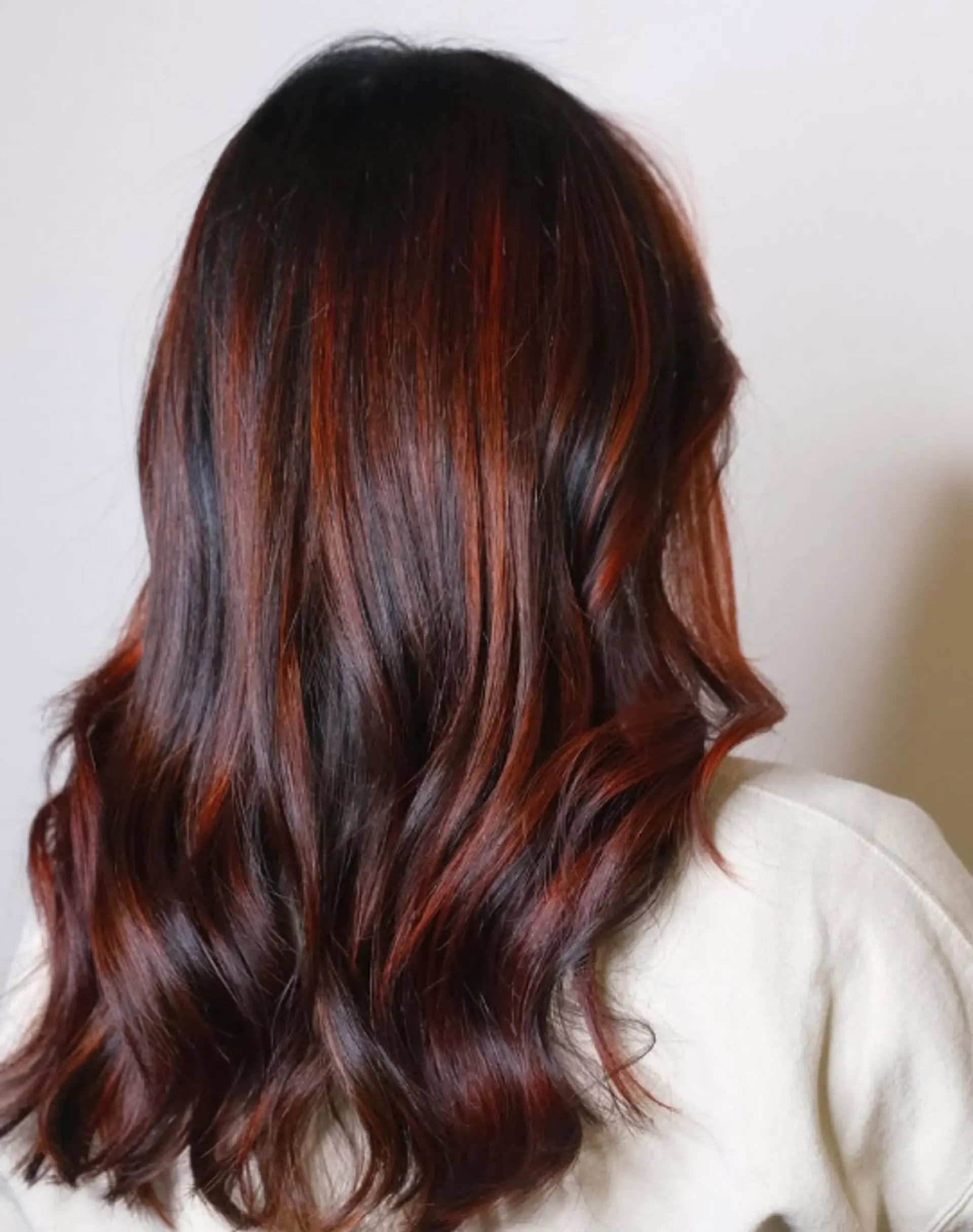 Long wavy hair with vibrant red highlights adding dimension and movement. 1
