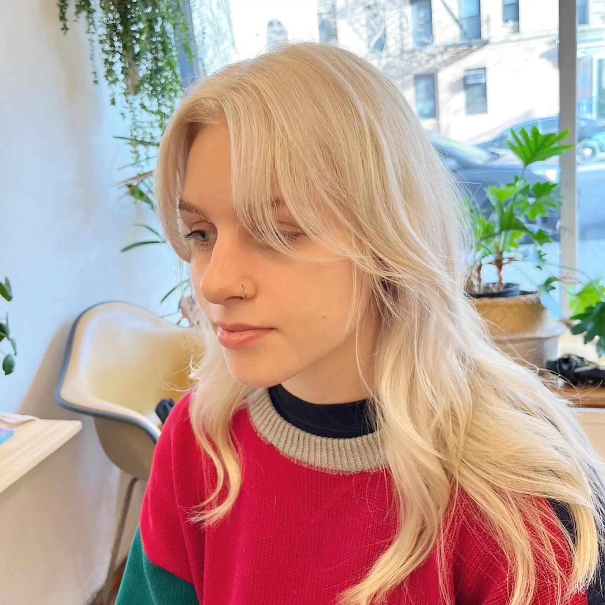 The hairstyle features long, platinum blonde hair with a wavy texture. It includes soft layers, face-framing layers, and curtain bangs. 🤍💛🤍#whiteblondehair by @limi.nyc  2