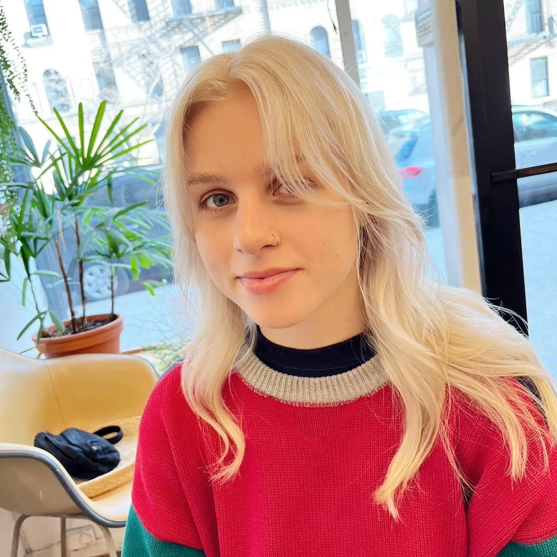 The hairstyle features long, platinum blonde hair with a wavy texture. It includes soft layers, face-framing layers, and curtain bangs. 🤍💛🤍#whiteblondehair by @limi.nyc  3