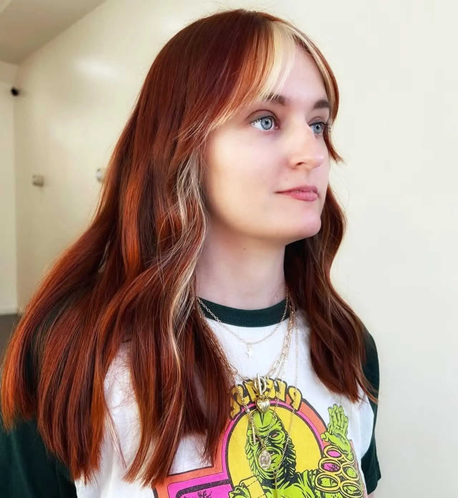 A medium length wavy cut with curtain bangs and face framing layers. 1