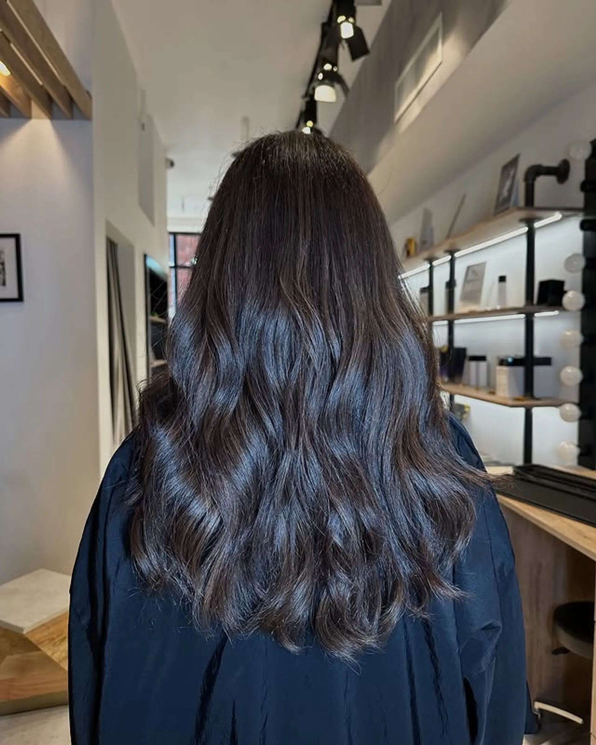 Long, wavy hair with soft waves and a glossy finish. 1