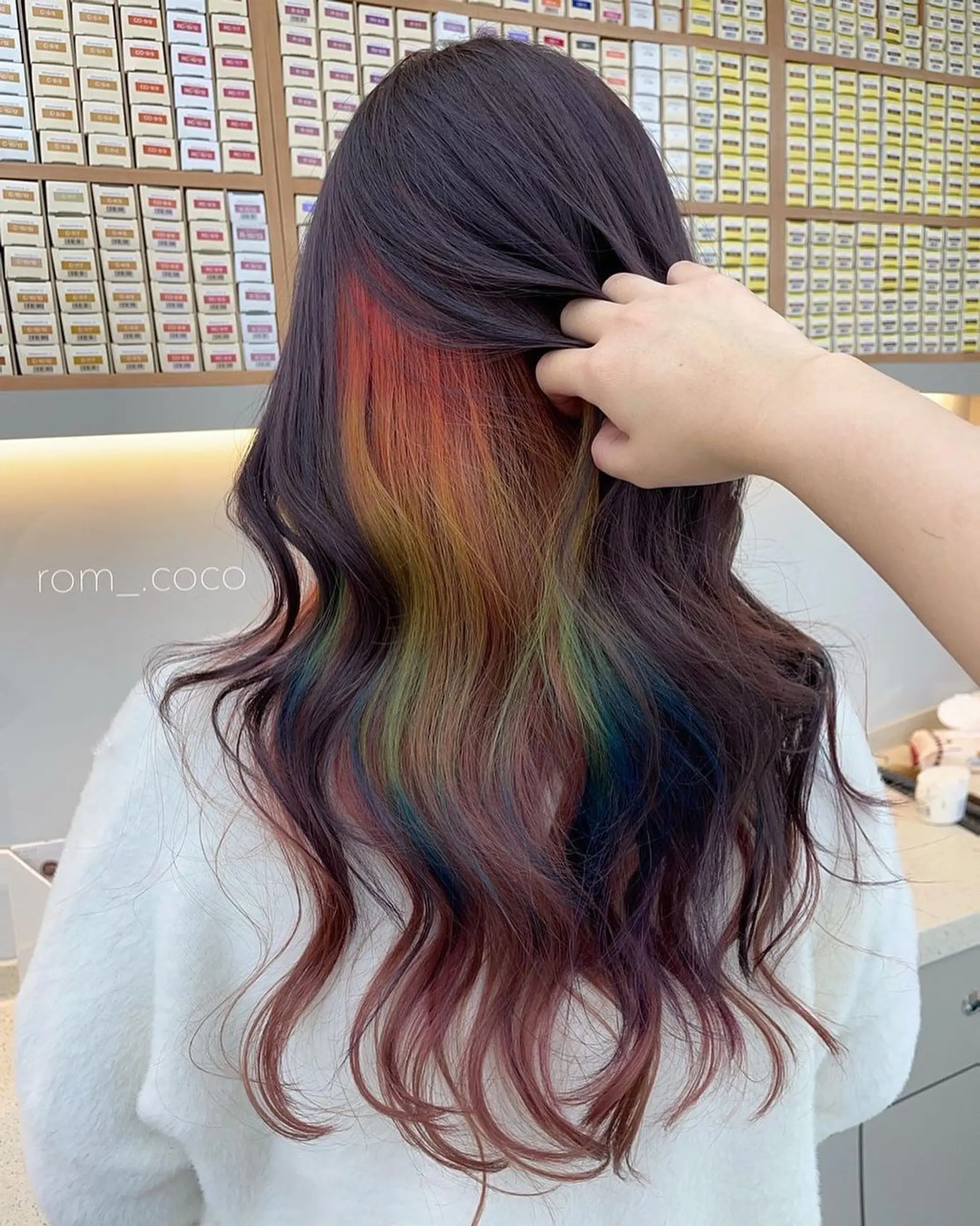 Long wavy hair with a hidden rainbow color melt. 1