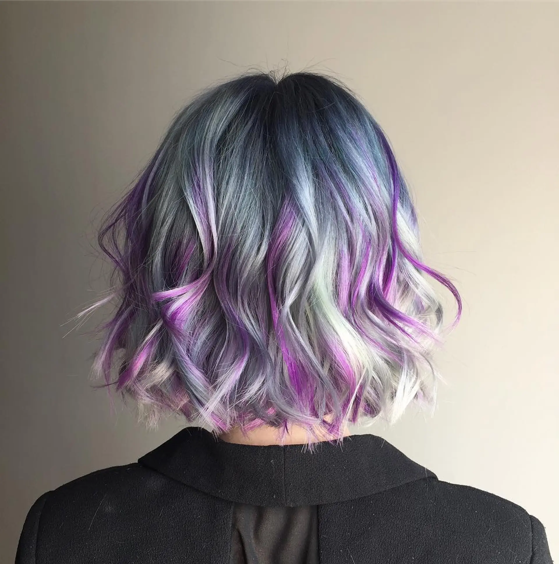 A medium-length wavy bob with a blend of gray, purple, and white colors. 1