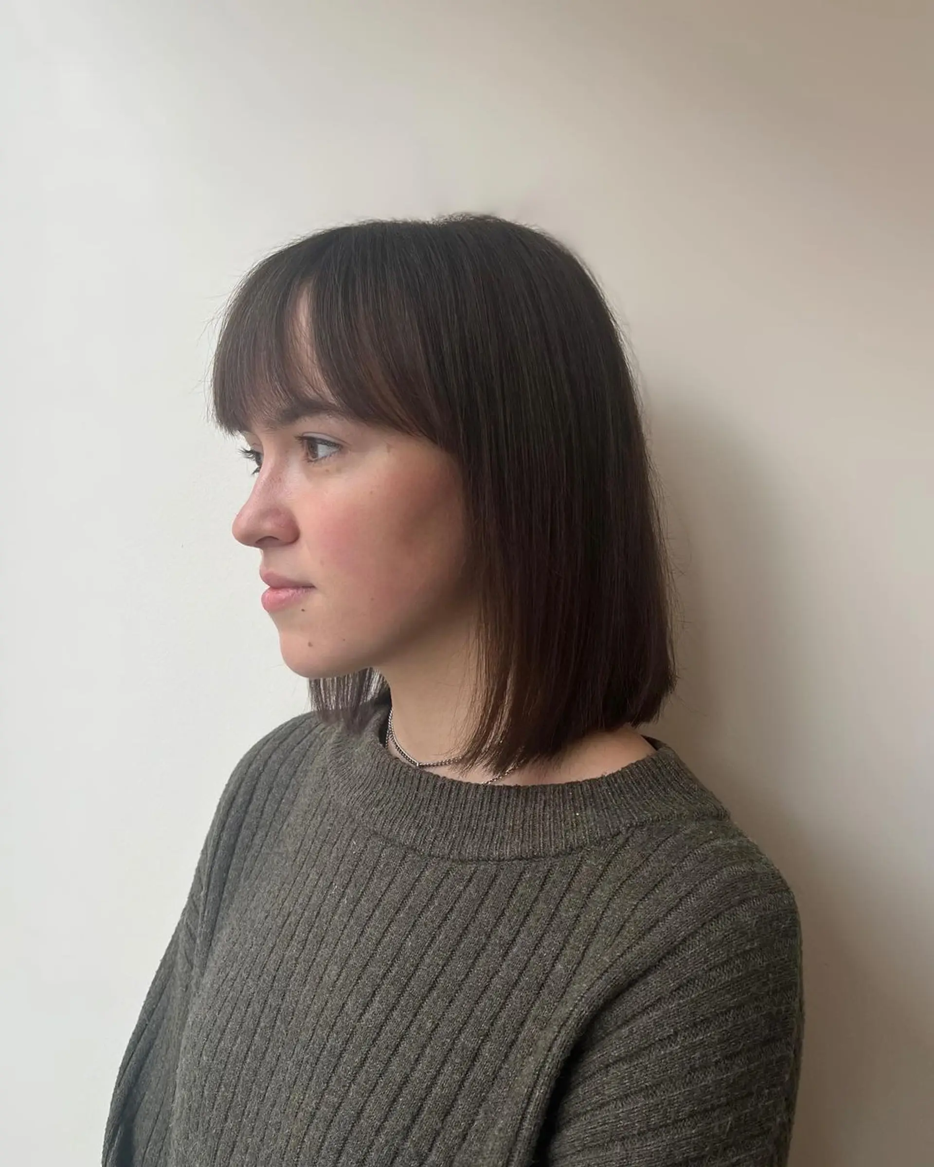 Medium-length, straight bob with a clean, blunt cut and a smooth, natural fringe. 1