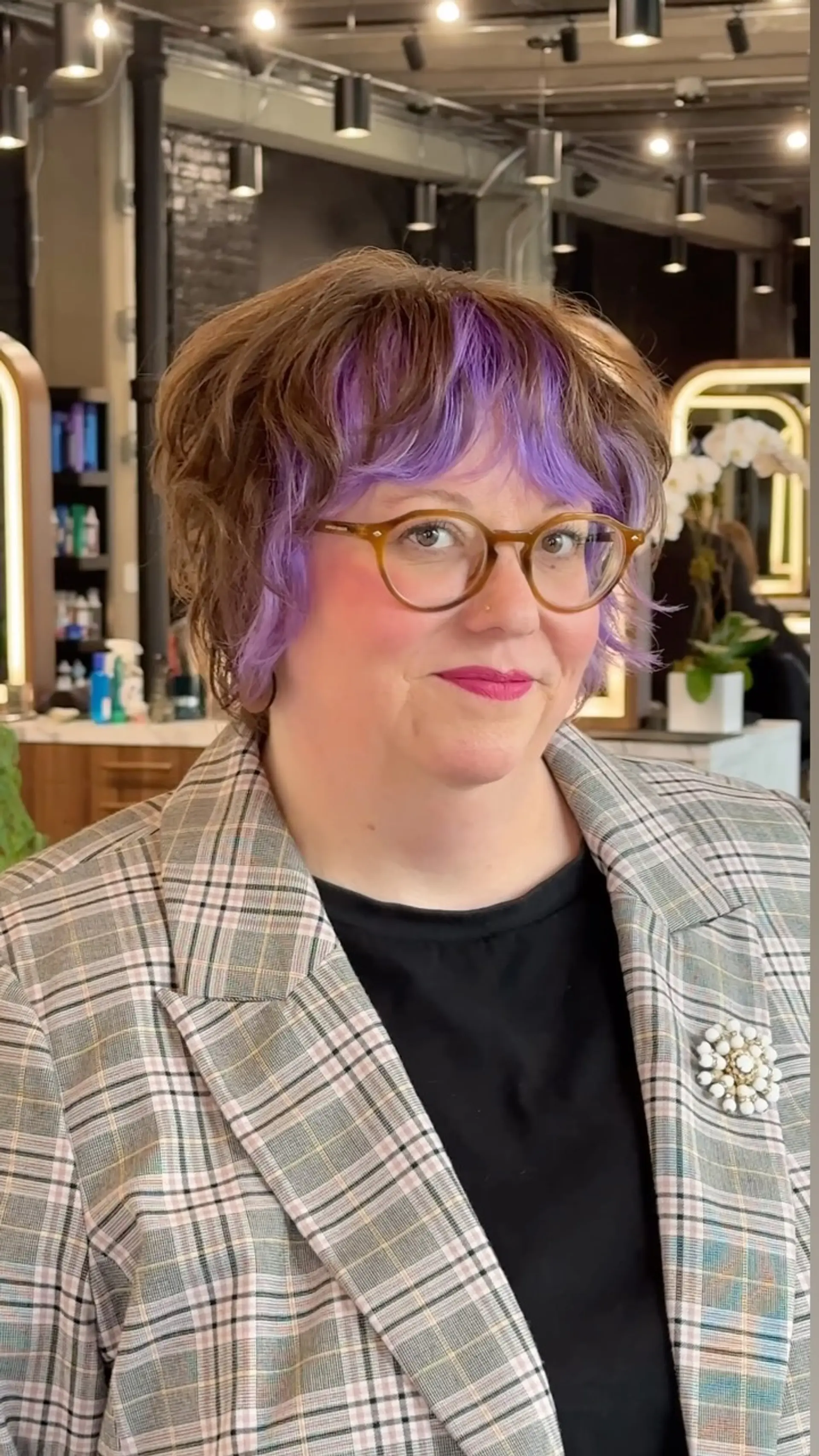 A textured wavy short cut accented with vibrant electric purple bangs and face-framing fringe. 1
