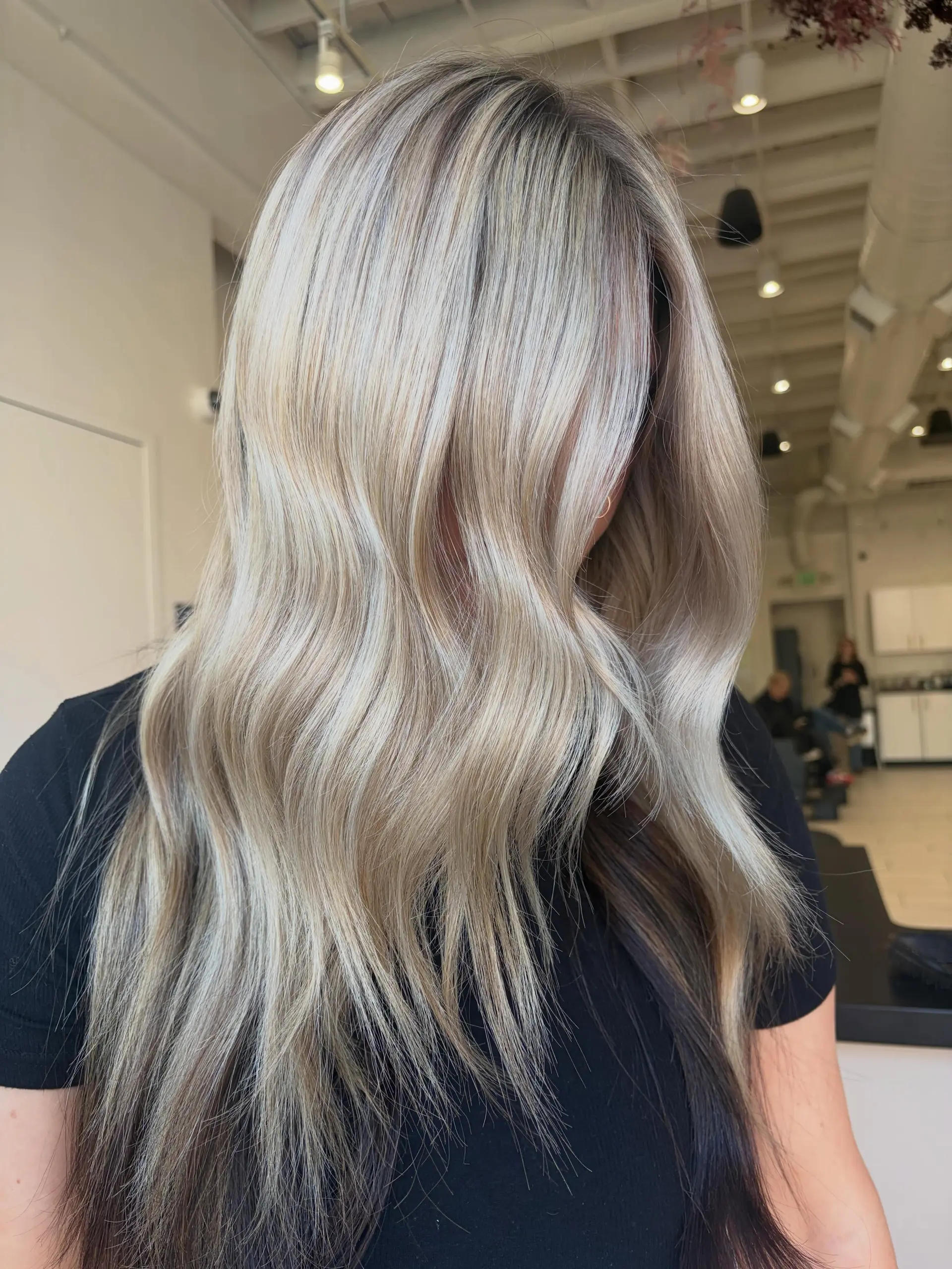 Long dimensional blonde hair styled in soft, relaxed waves with depth underneath. 1