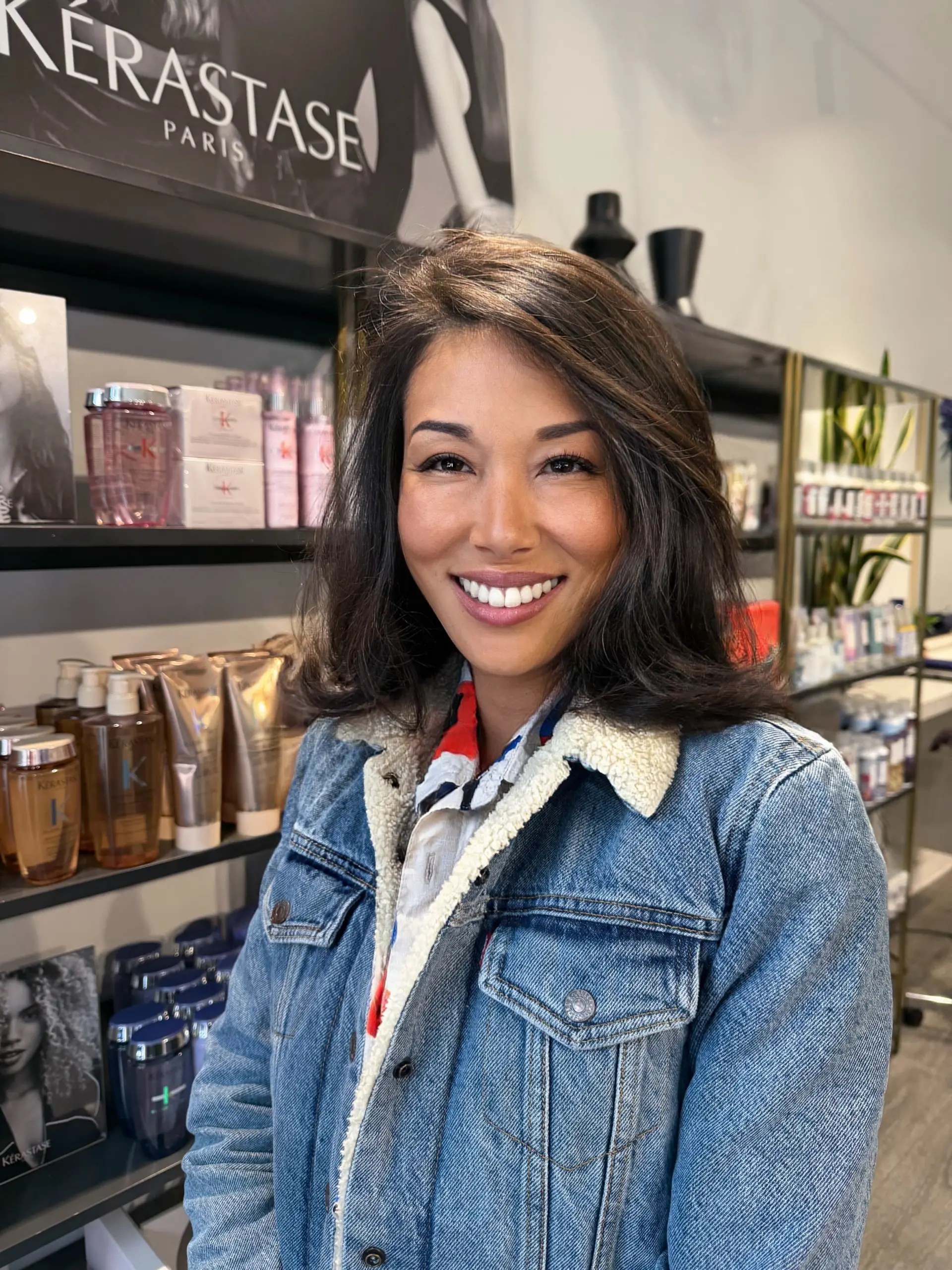 A textured shoulder-length lob with soft face-framing layers, a deep side part, and a voluminous blowout with flipped ends. 1