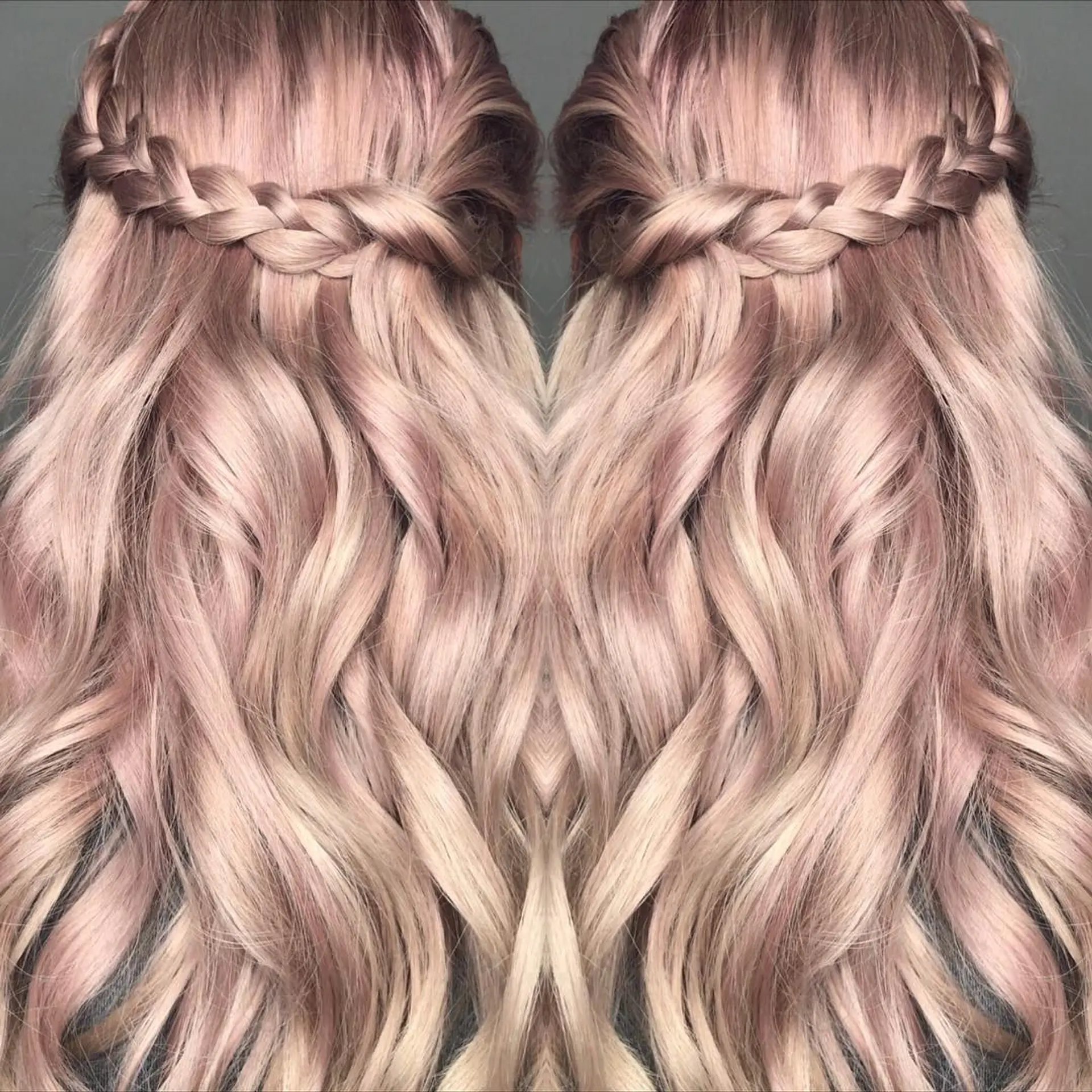 Long titanium rose and pastel blonde hair styled with cascading soft waves and an intricate crown braid across the back. 1