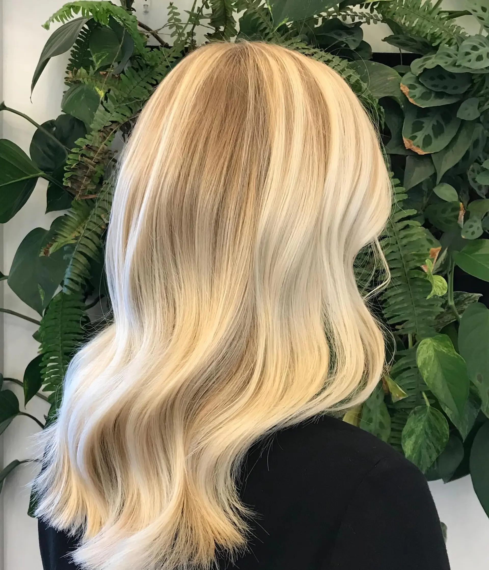 Bright dimensional blonde hair styled in soft, loose waves. 1