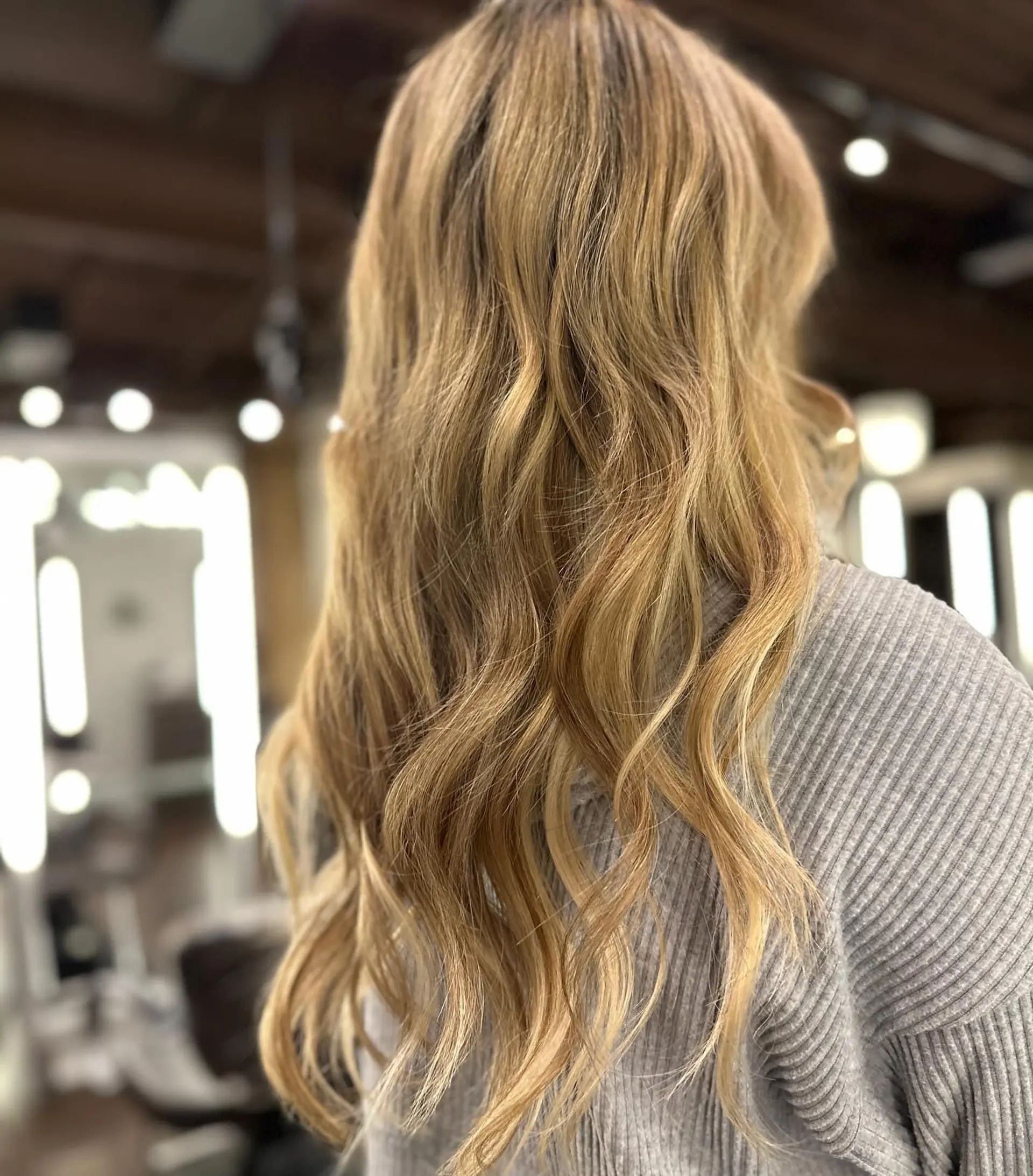 Long, wavy hairstyle with golden blonde balayage highlights. 1