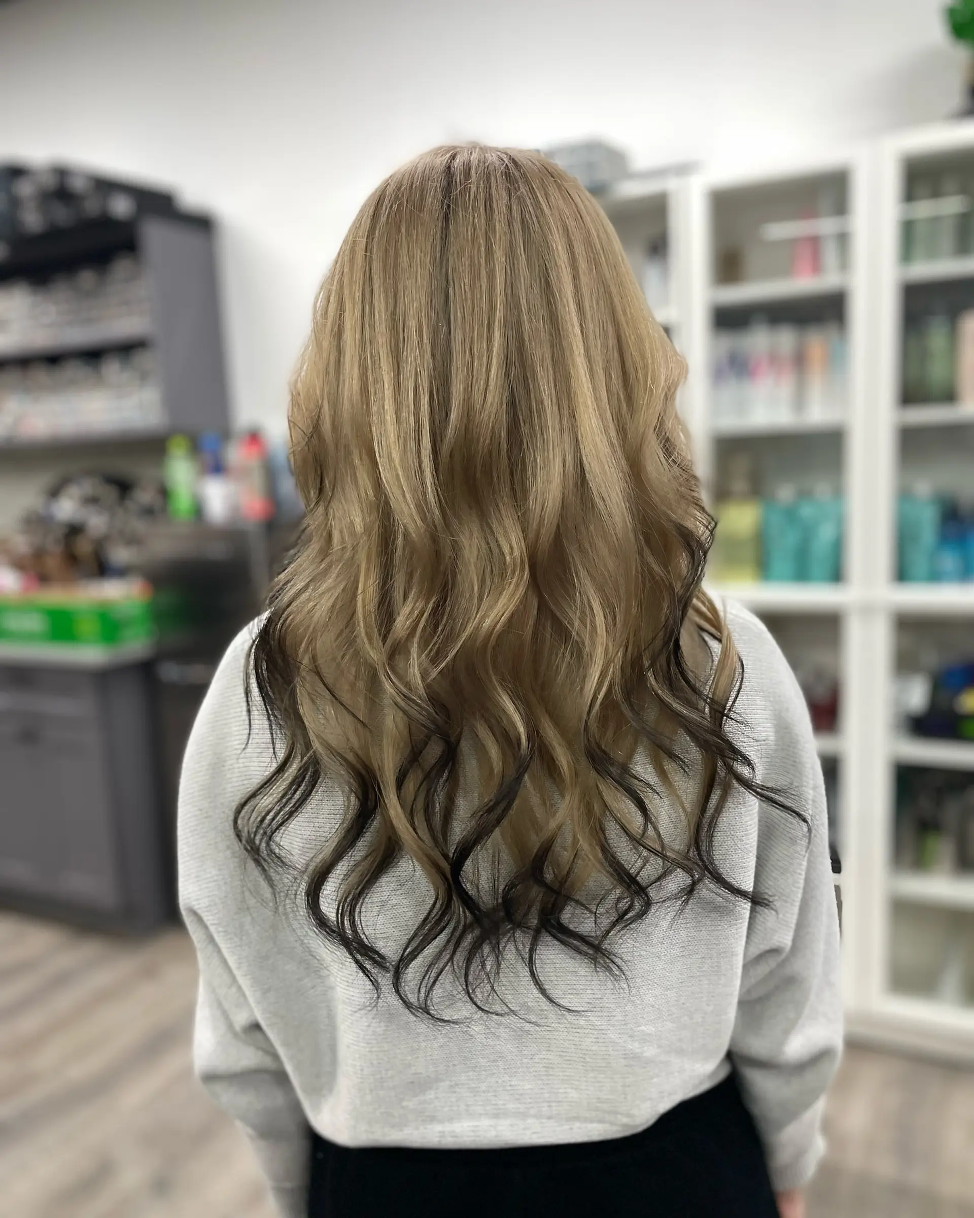 Bronde balayage with a dark shadow root and soft waves. 1