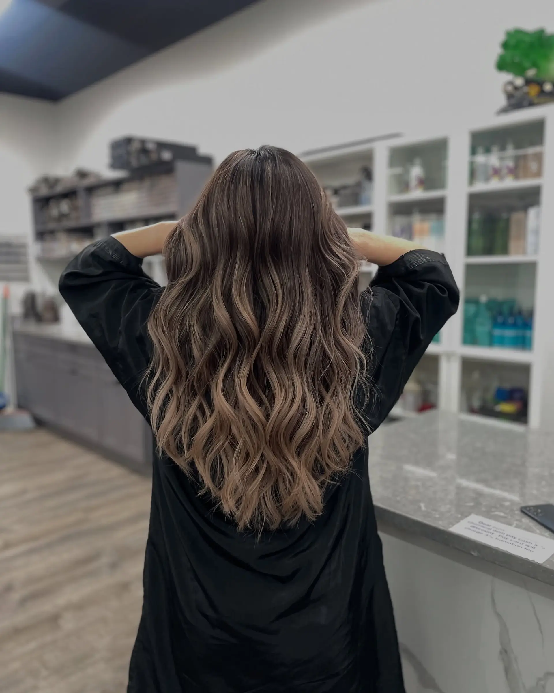 Long, wavy hair with a balayage bronde color. 1