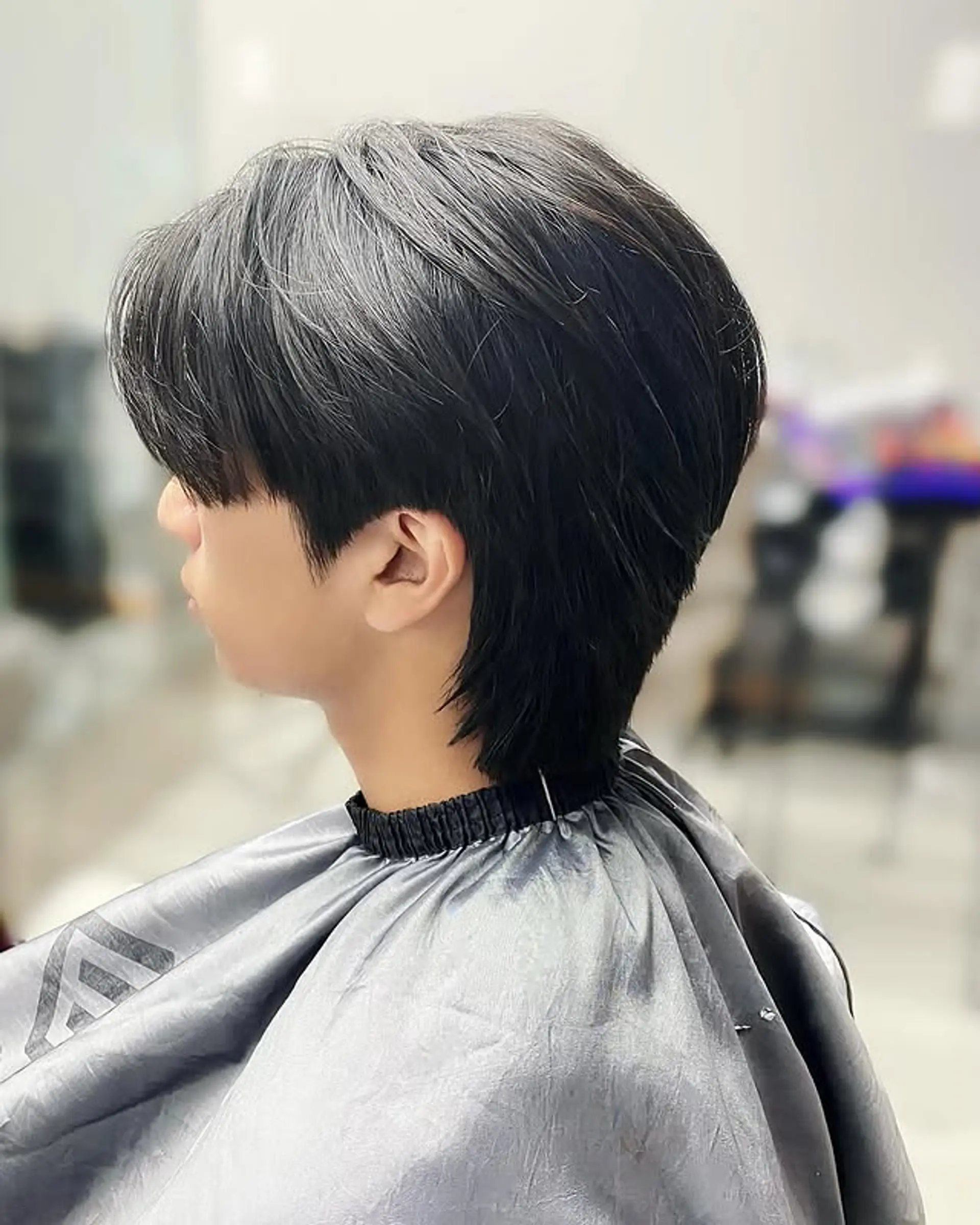 A modern take on the classic mullet, featuring a shorter, textured top with longer hair in the back. 1
