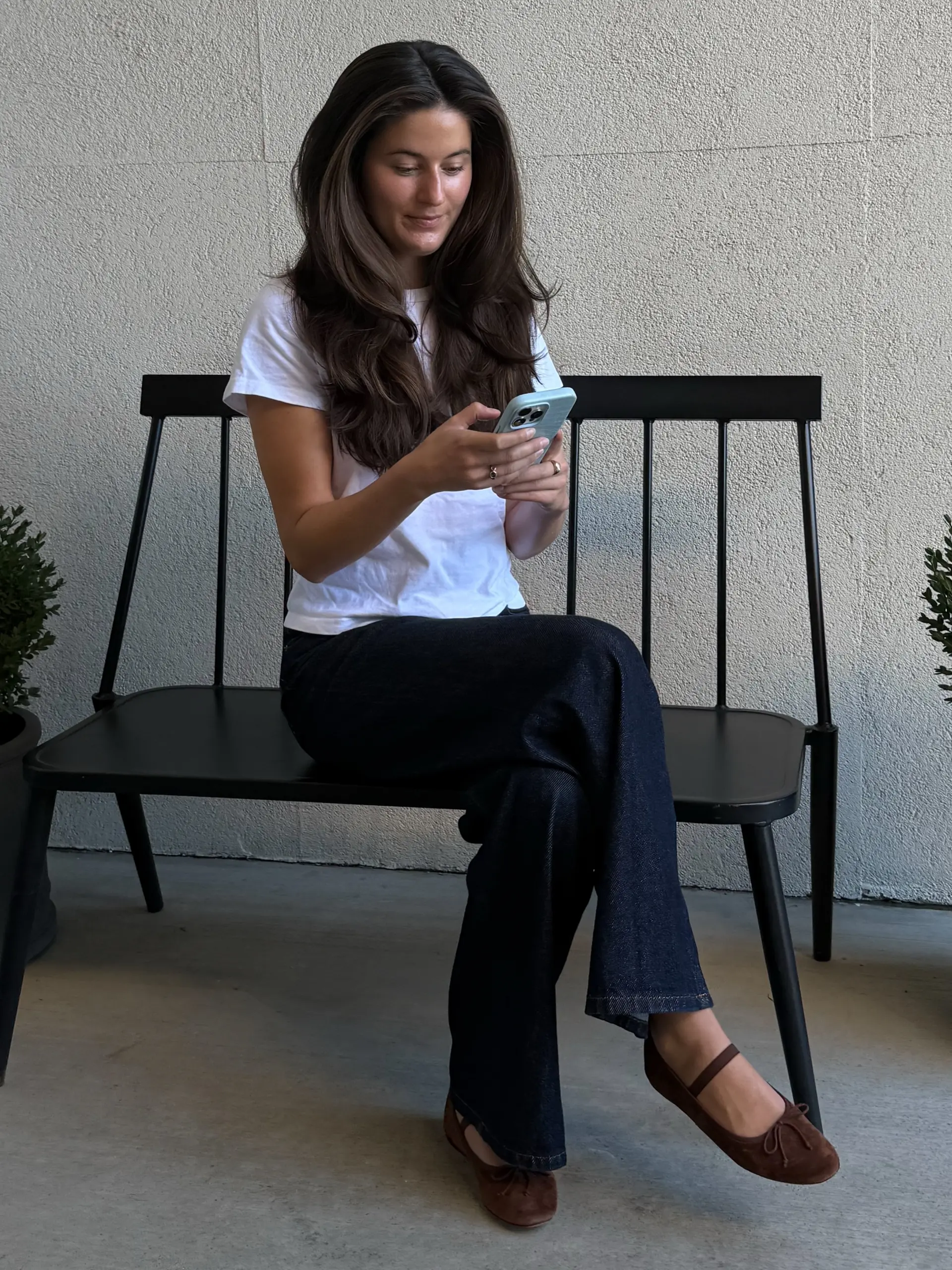 Long dark brunette hair featuring face-framing layers and a voluminous, bouncy blowout finish. 1