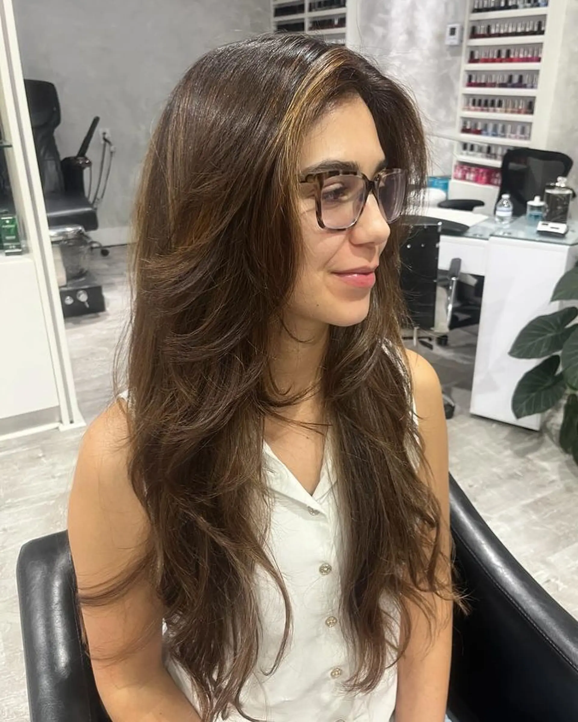 A long, straight hairstyle with layers throughout, and lighter blonde highlights around the face. 1