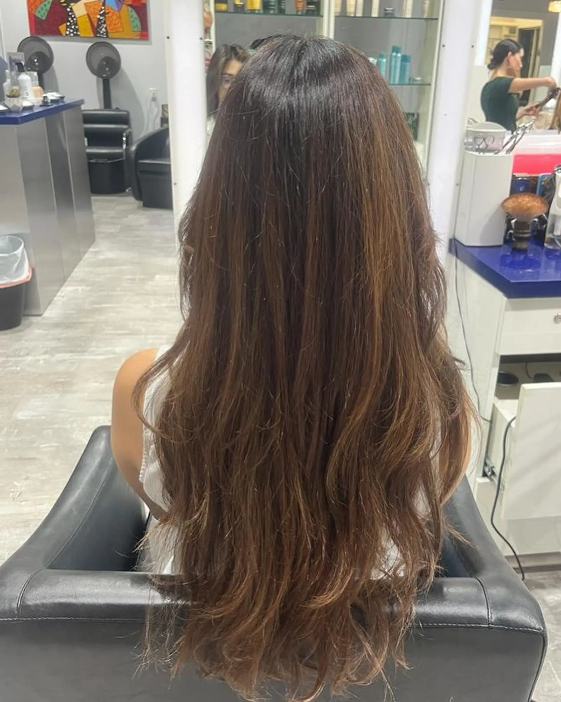 A long, straight hairstyle with layers throughout, and lighter blonde highlights around the face. 2
