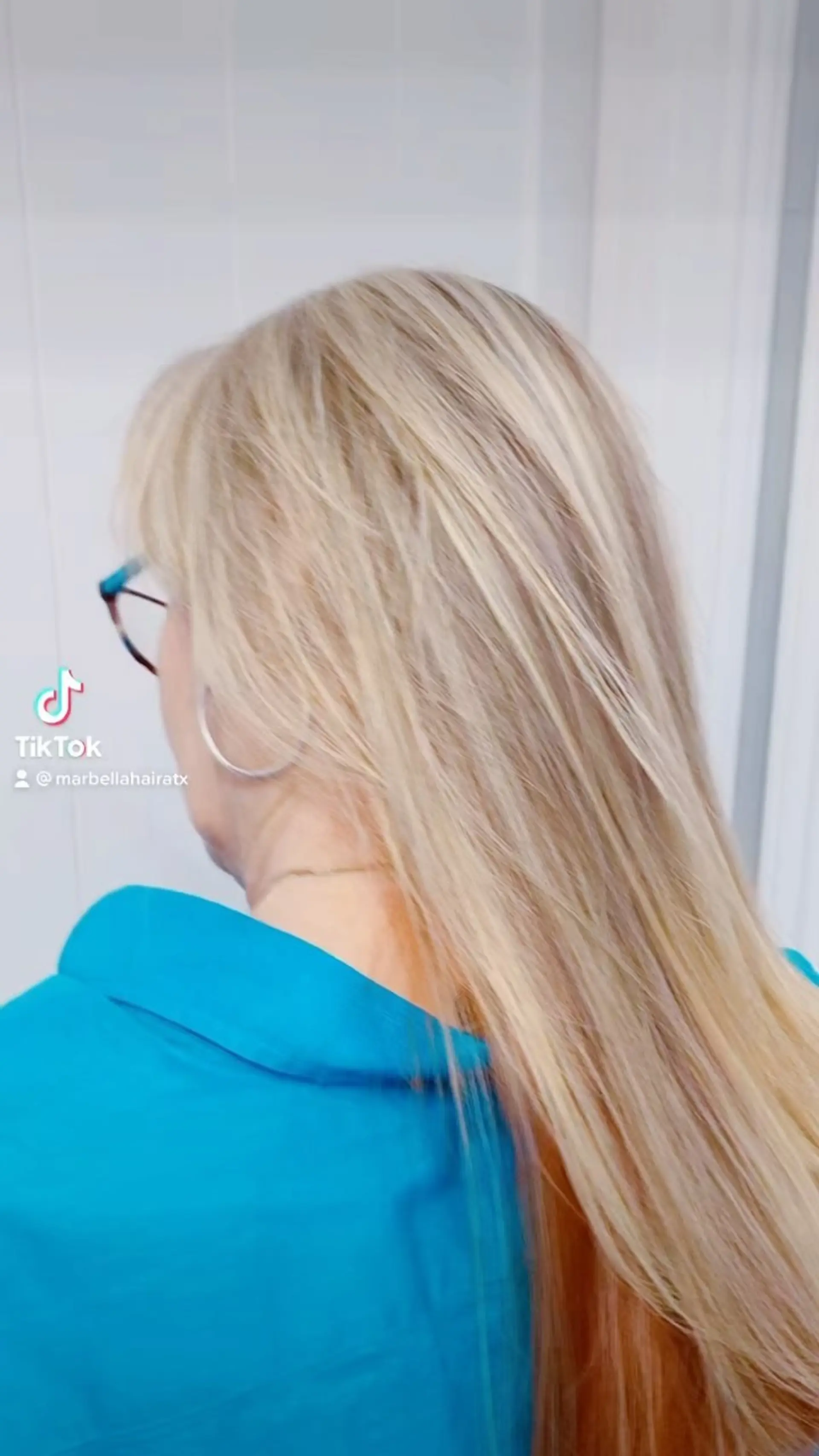 Straight long blonde hair accented with a hidden peek-a-boo copper underlayer. 1