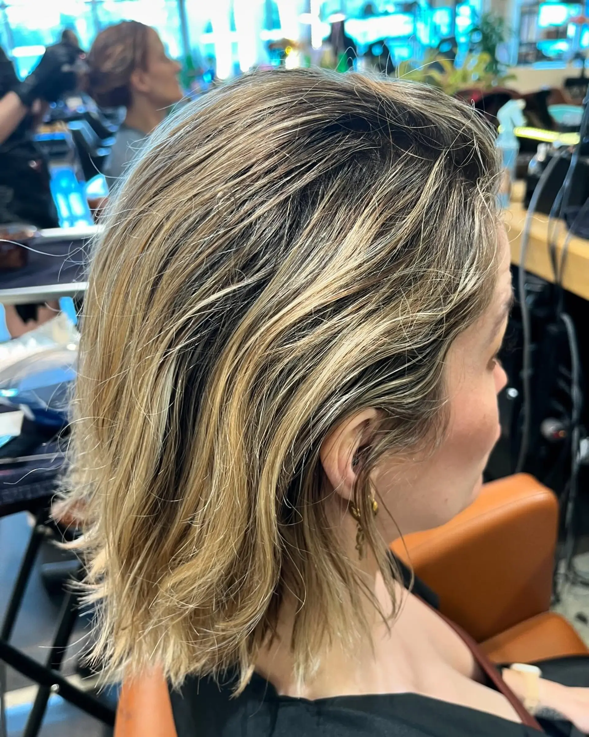 A textured collar-length bob with multi-tonal blonde highlights and a face-framing money piece. 1