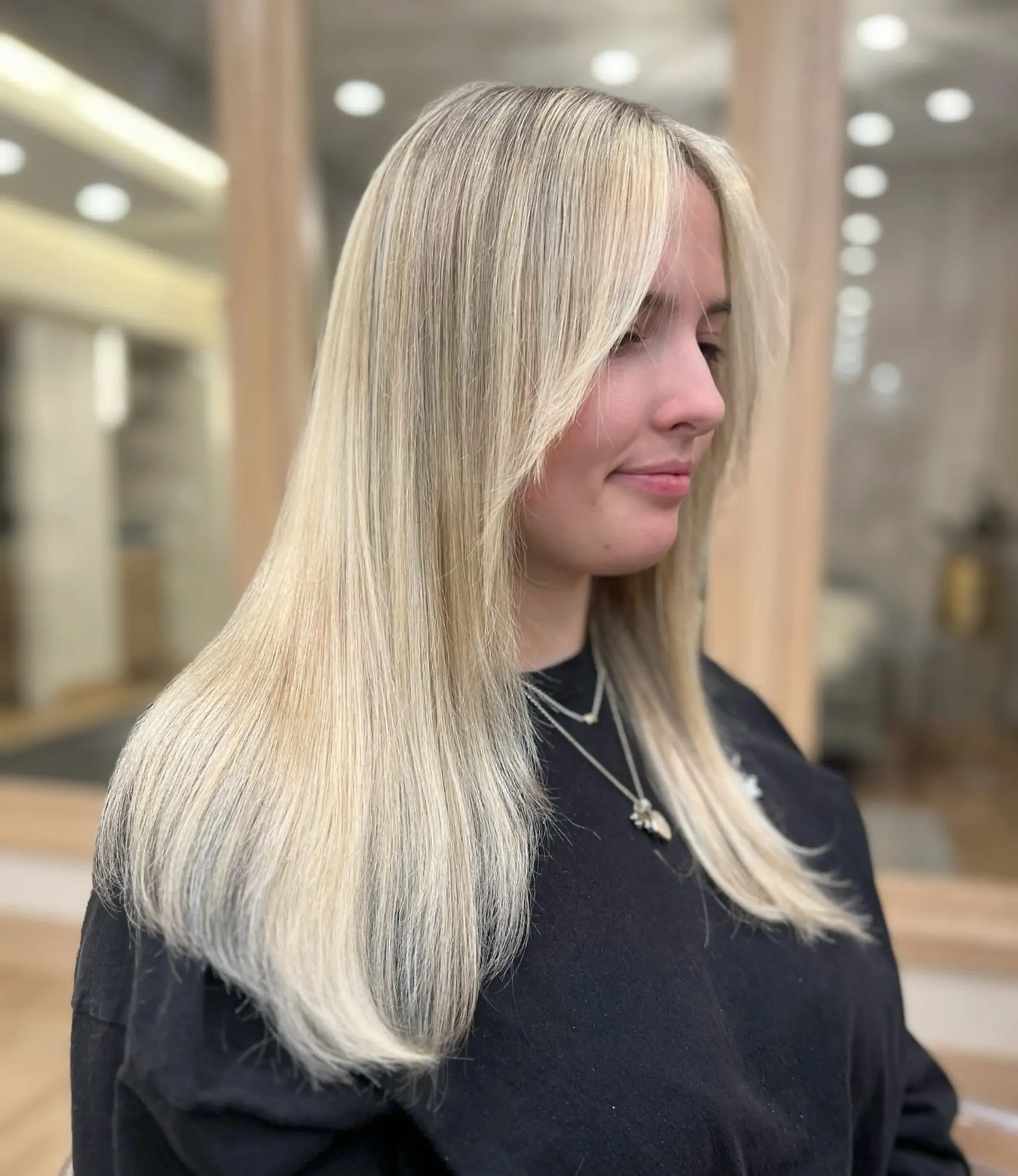 A long layered hairstyle with trendy curtain bangs. 1