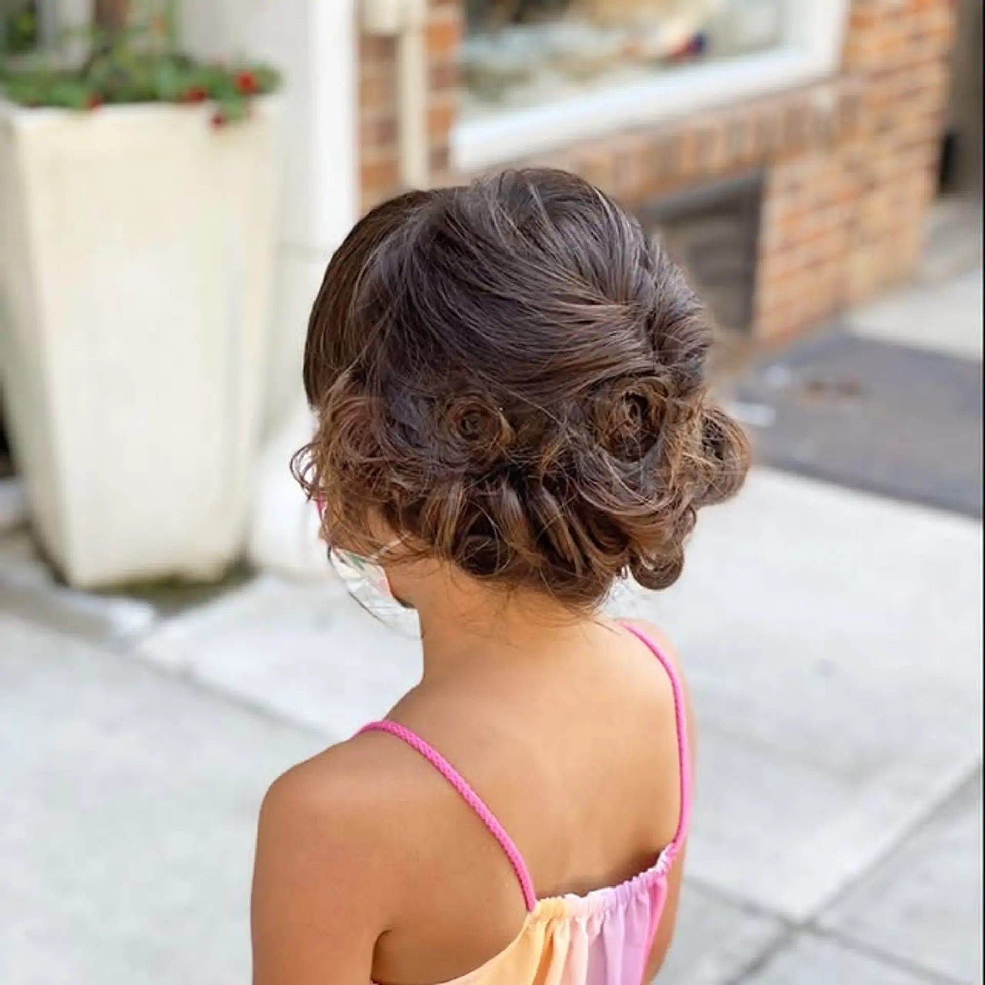 A beautifully twisted and pinned updo with soft, curly ends. 1