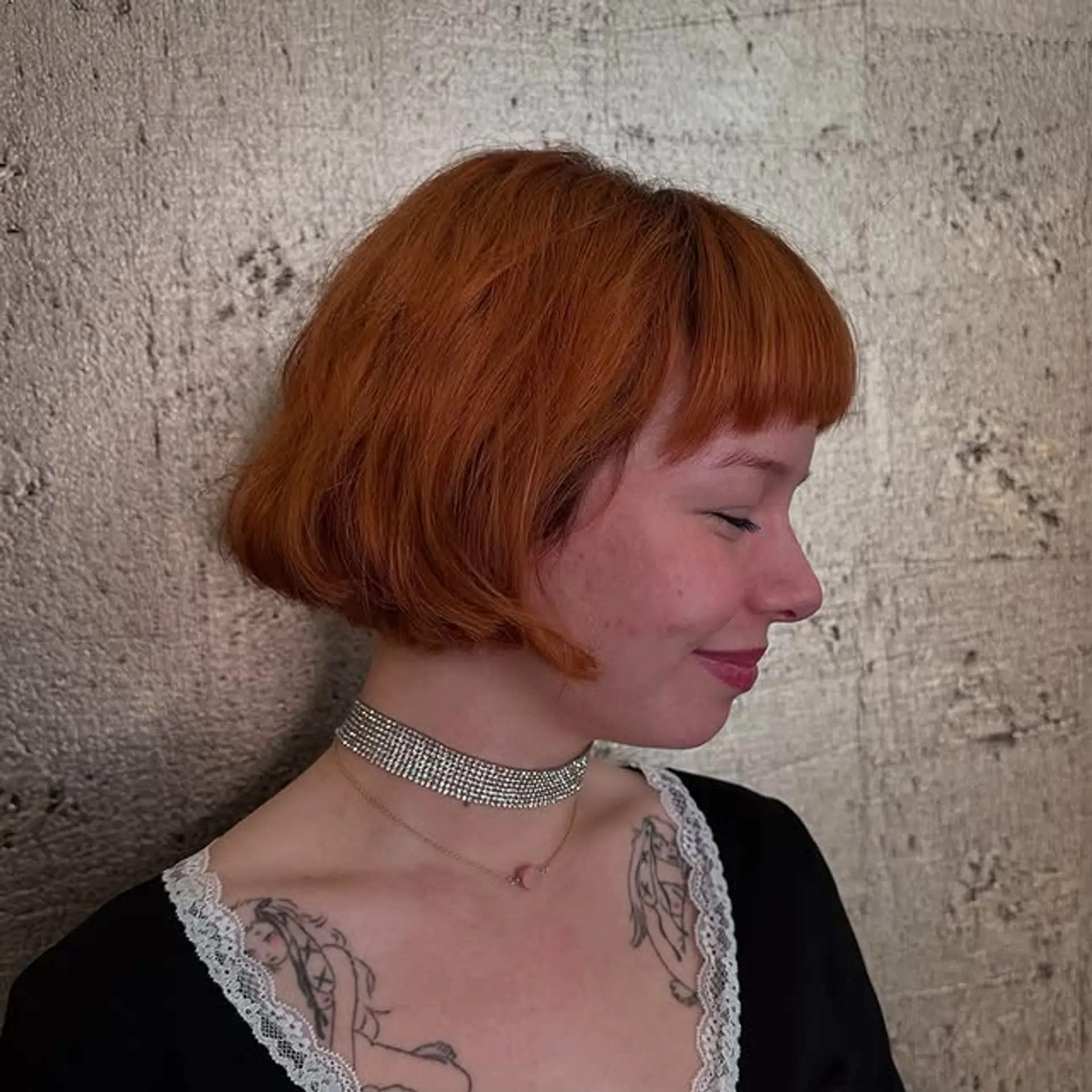 A short, wavy bob with blunt bangs. 1