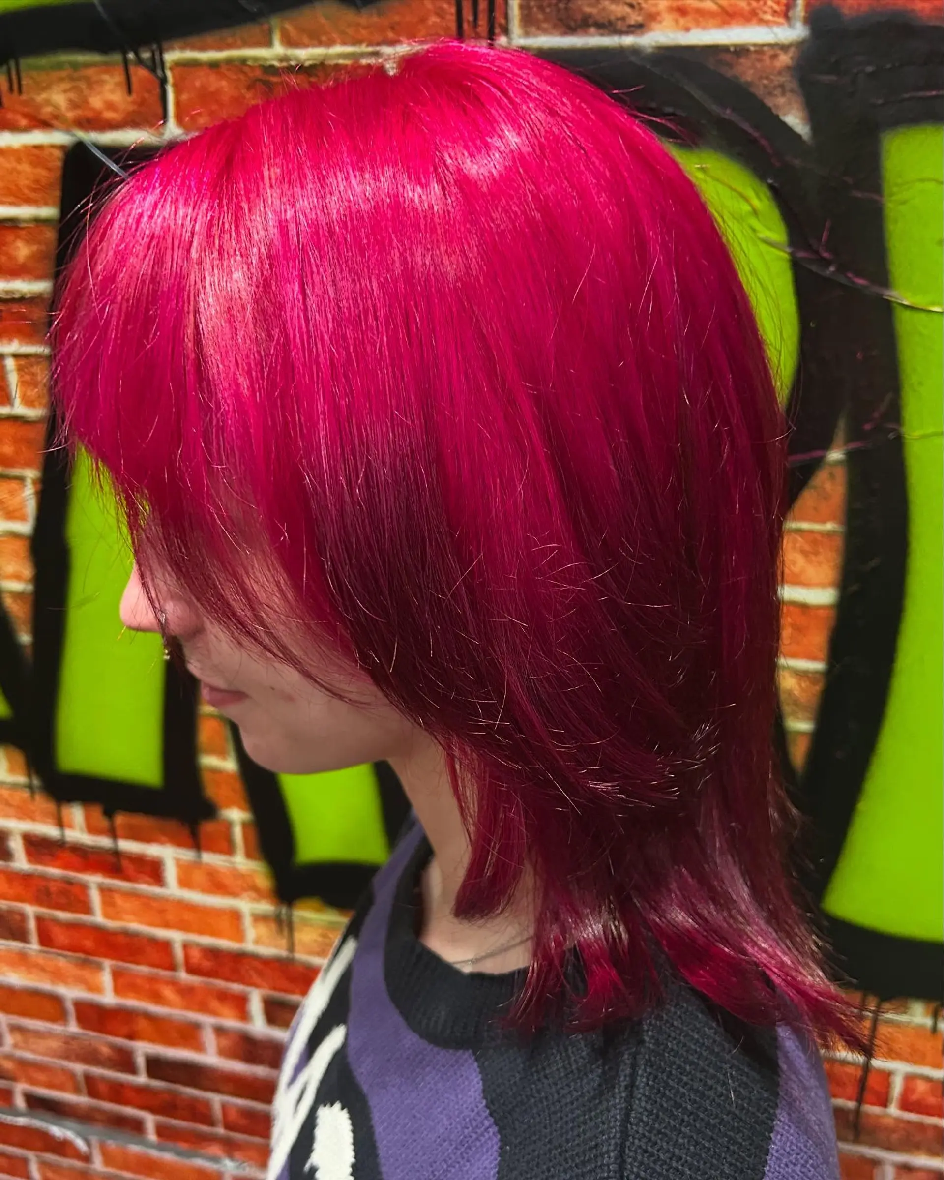 A bold, all-over hot pink layered shag haircut with choppy face-framing fringe. 1
