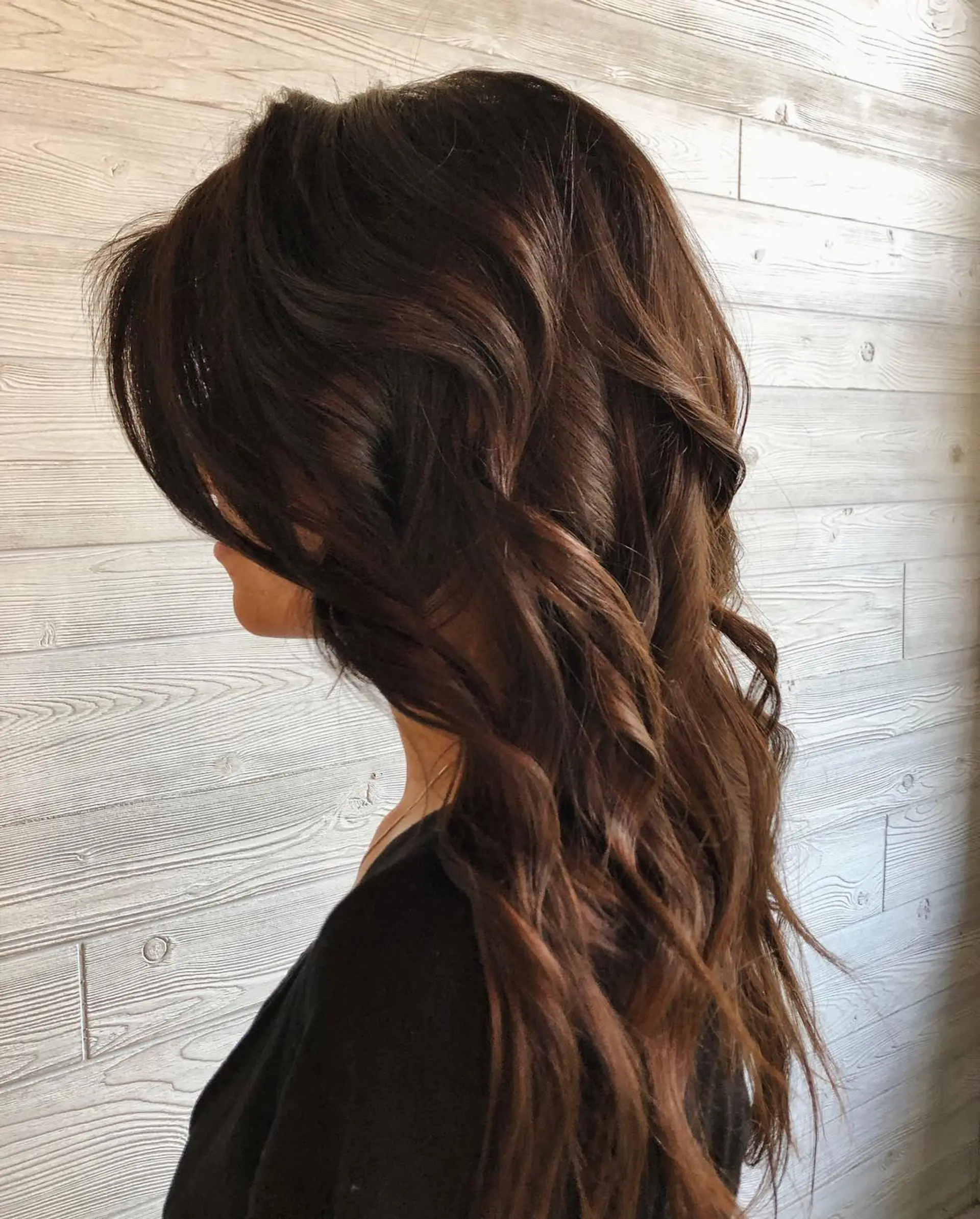 Long chocolate brown hair featuring subtle dimensional tones and styled in soft, cascading waves. 1