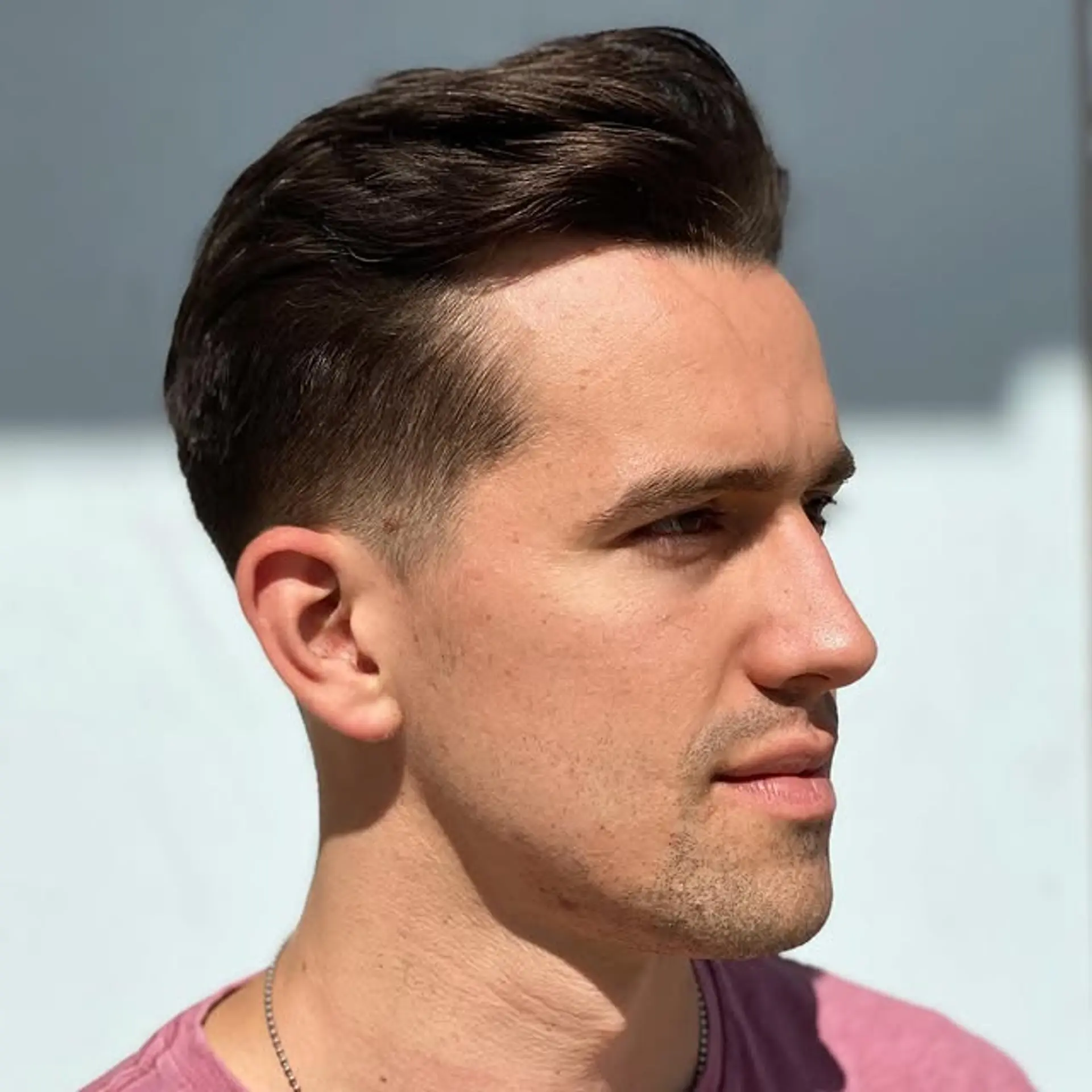 A classic medium-length haircut with tapered sides and a longer, textured top styled for volume. 1