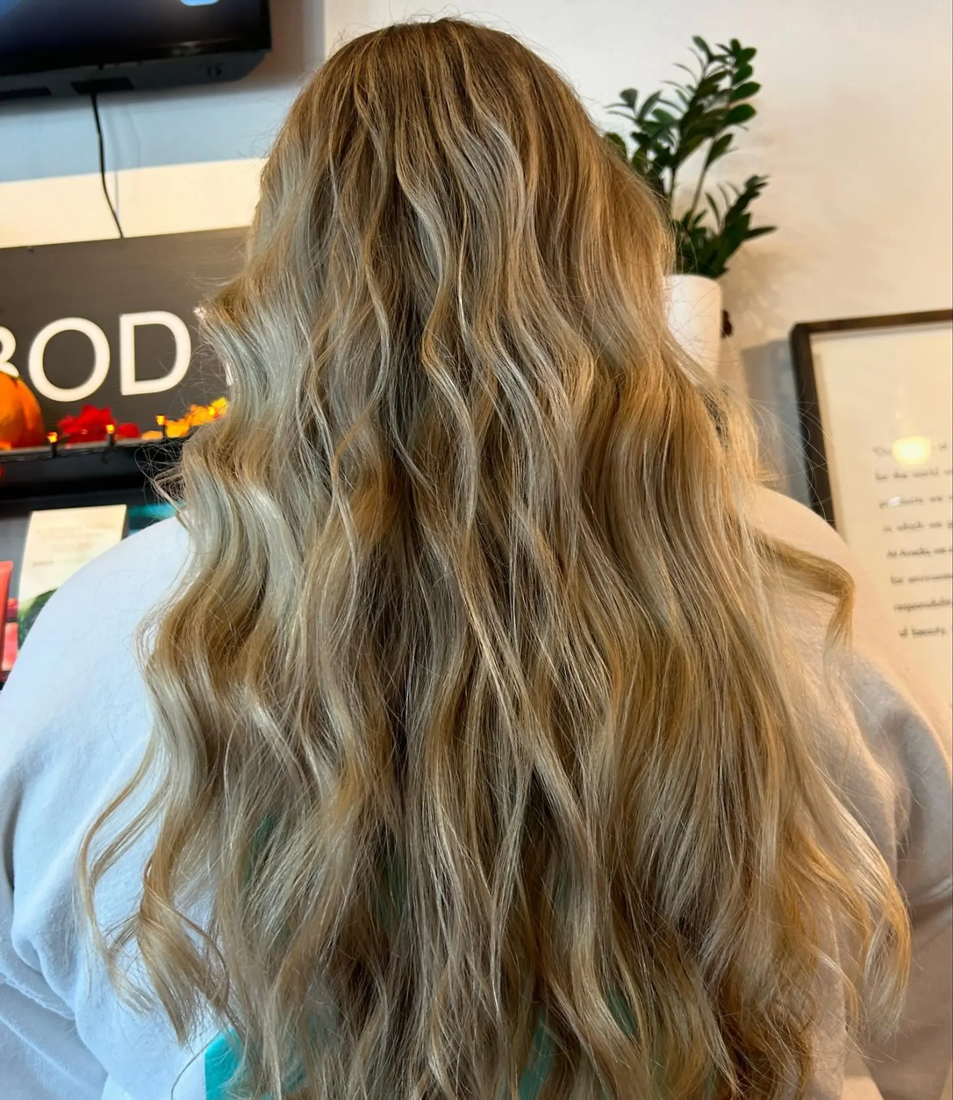 Long hair featuring dimensional blonde balayage styled with relaxed, textured waves. 1