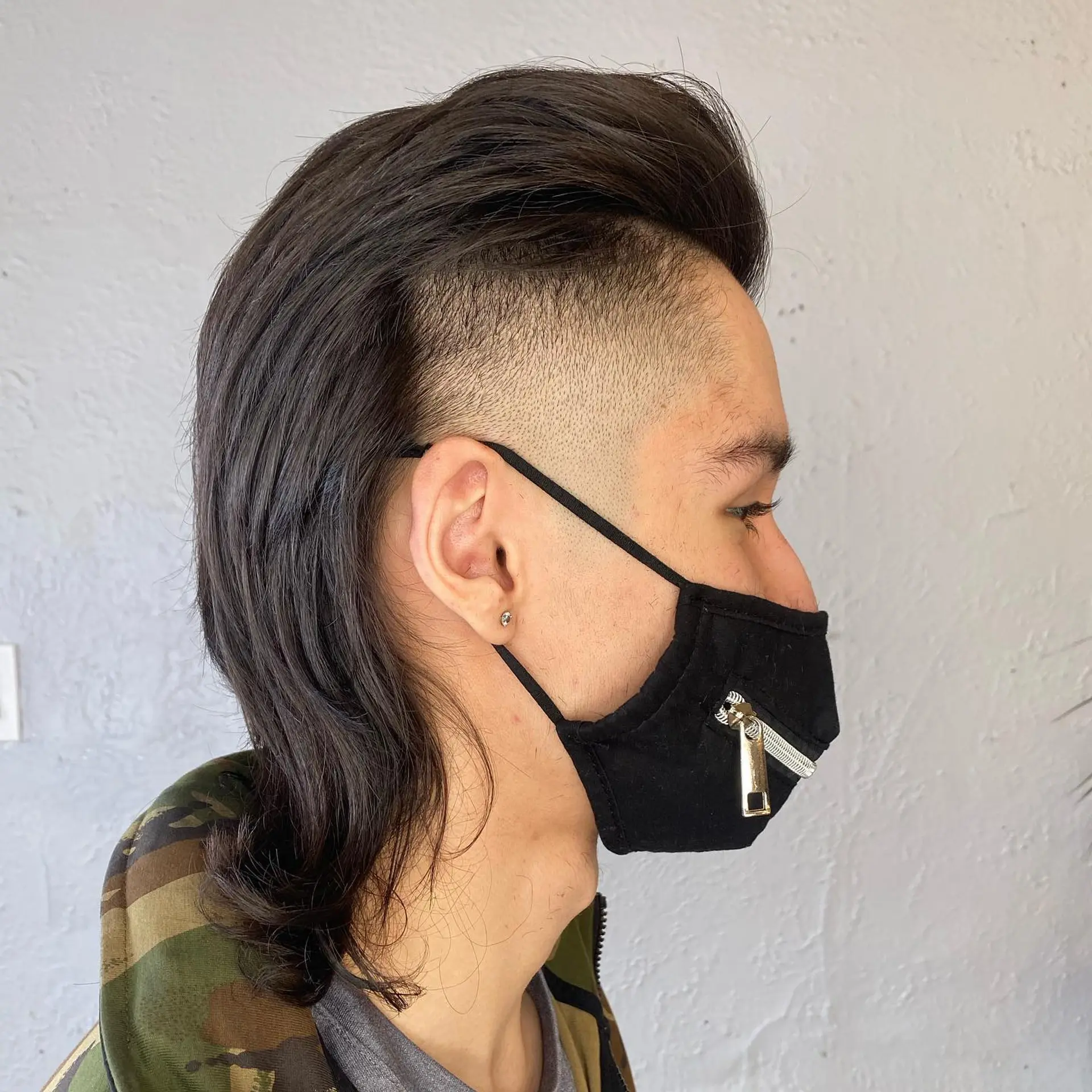 A modern take on the classic mullet, featuring a faded undercut and longer length in the back. 1