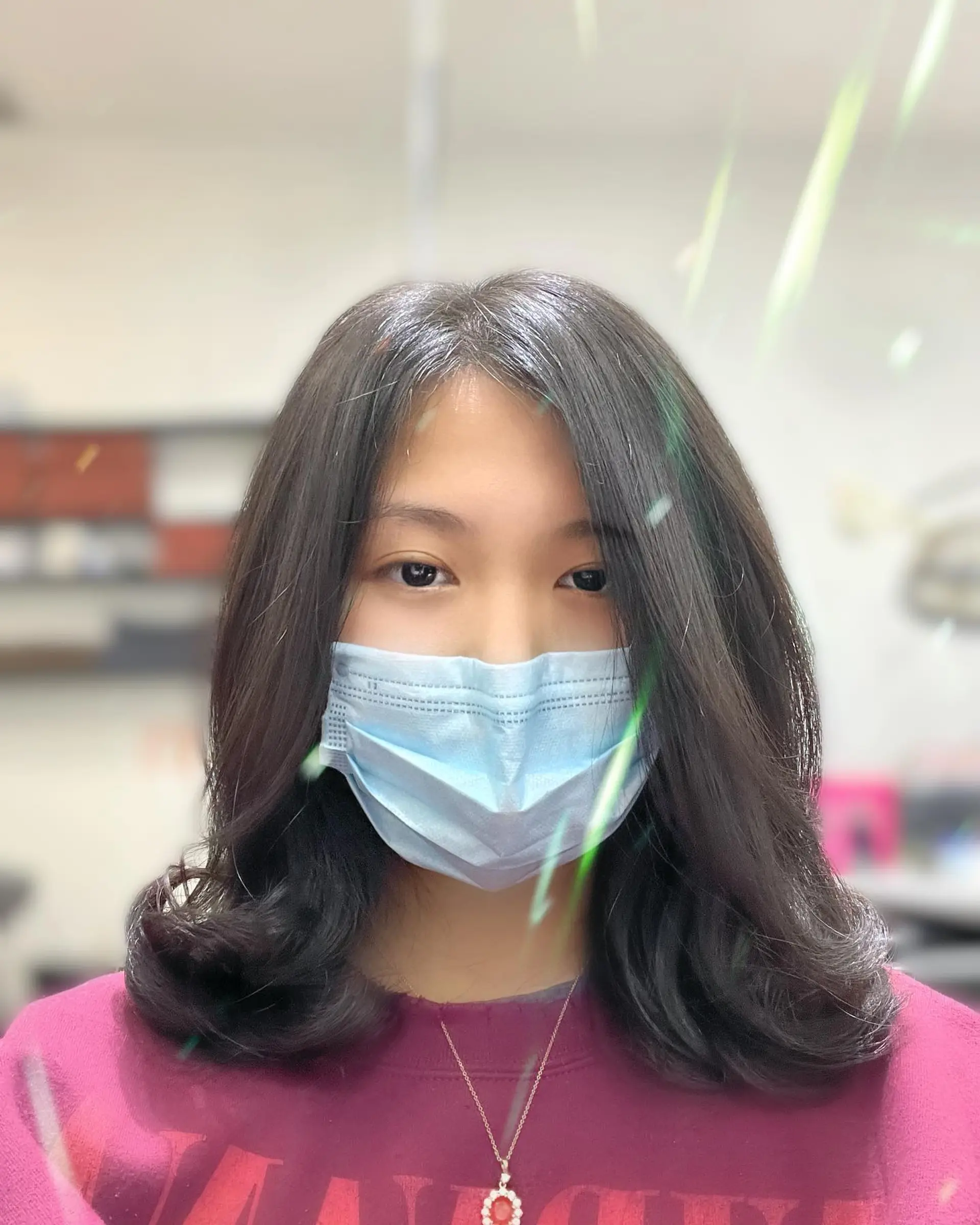 A medium length hairstyle featuring soft waves and face-framing layers. 1