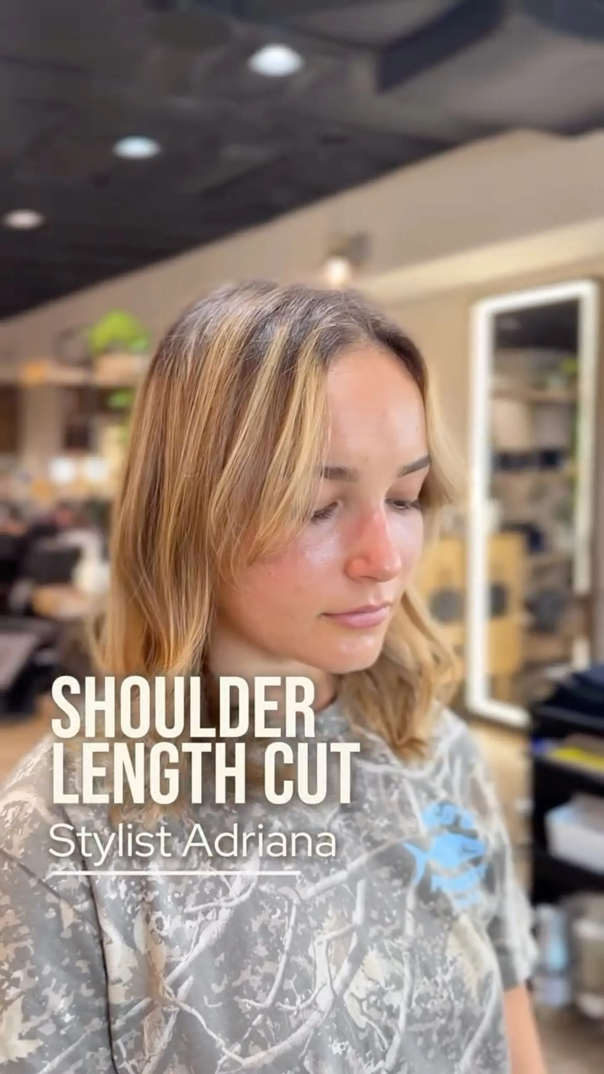 A textured shoulder-length cut featuring soft curtain bangs and subtle face-framing layers. 1