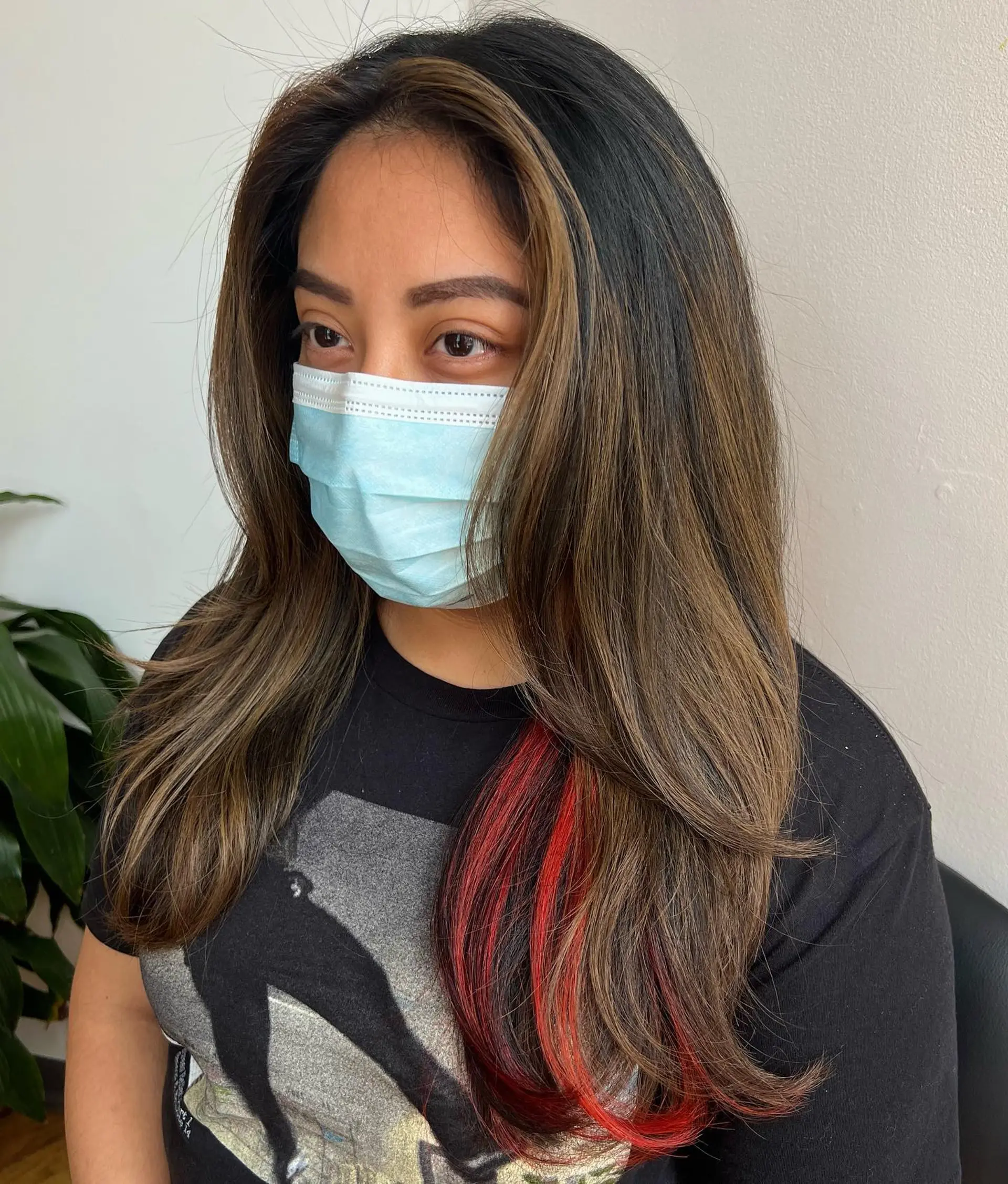 Long layered hair with face-framing caramel highlights and hidden red peekaboo highlights. 1