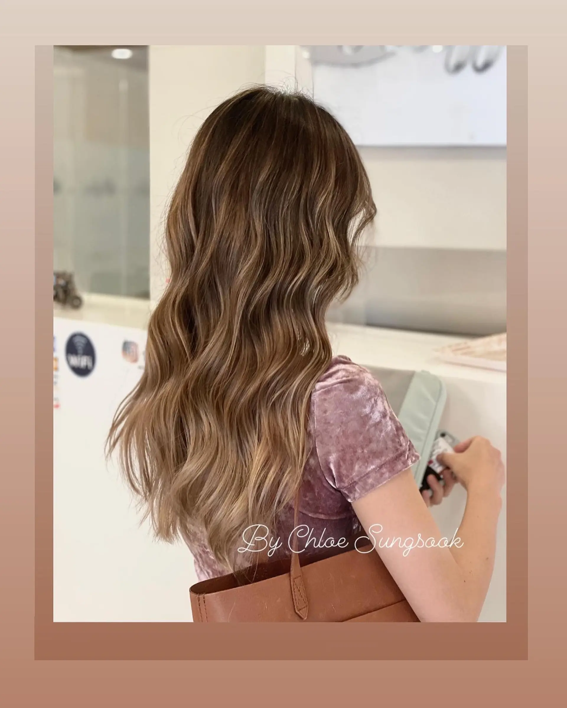 Long cascading waves featuring a dimensional, warm camel brown balayage. 1