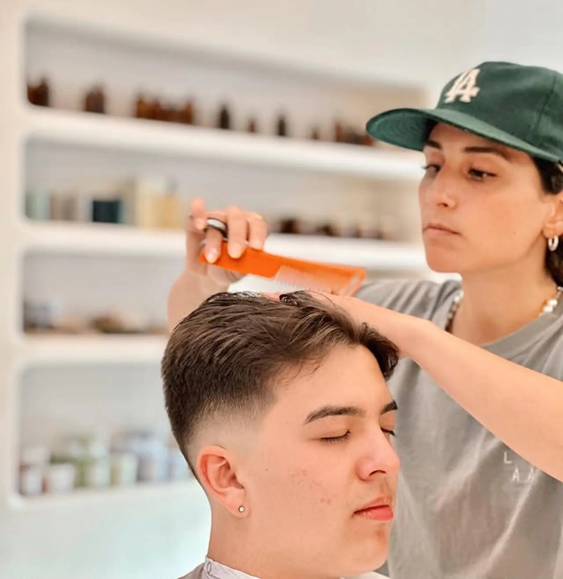 A stylish faded taper haircut with a textured top. 1