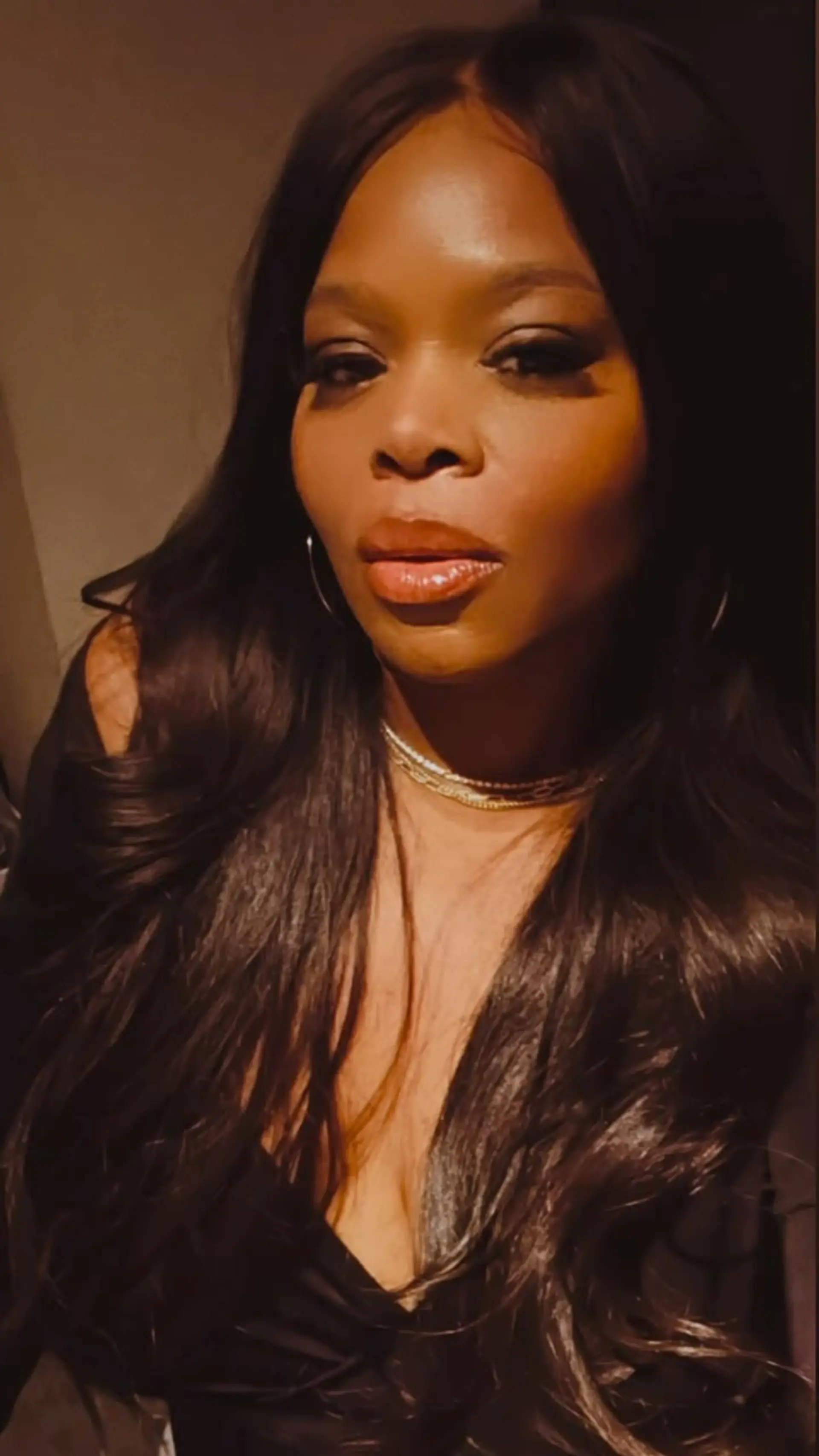 Long, flowing dark hair styled with a center part and voluminous, soft loose waves. 1