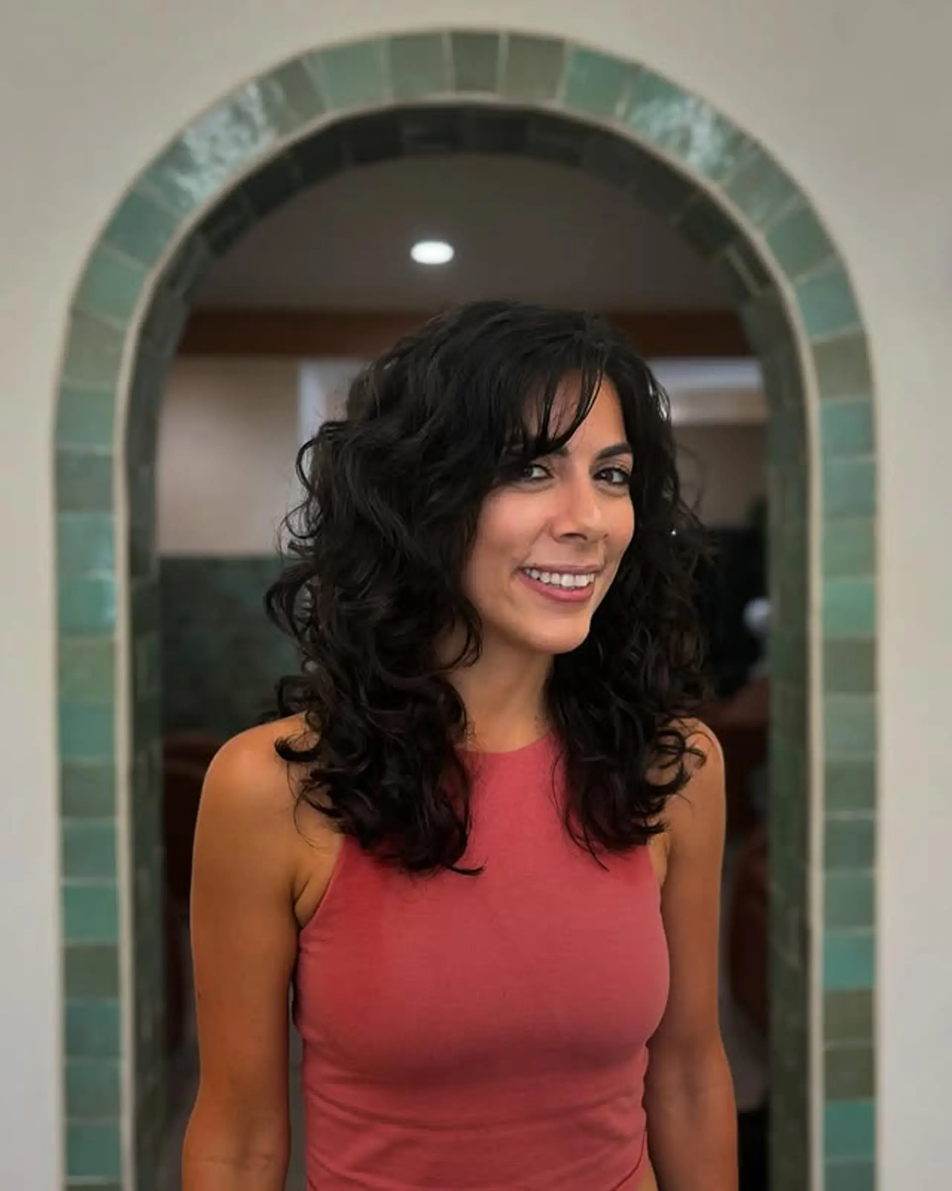 A curly shag with layered texture and full bangs. 1