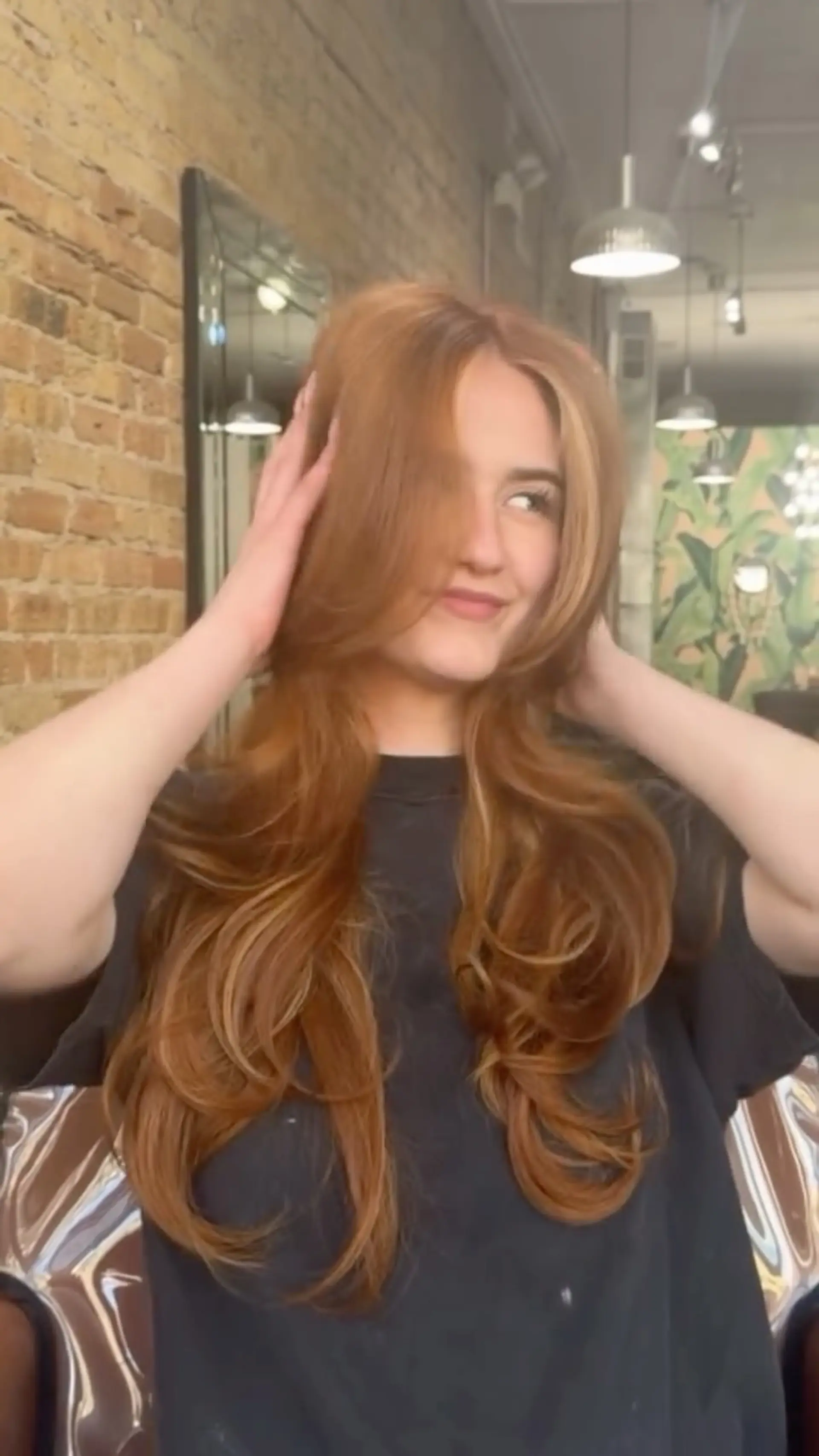 Long, flowing copper hair styled with voluminous layered blowout curls and bright blonde face-framing highlights. 1