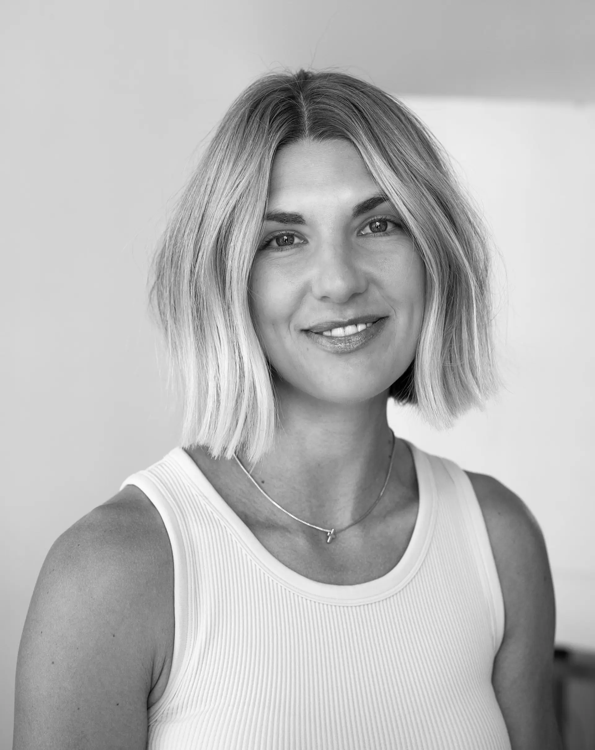 A textured, soft blunt bob cut falling just at chin-to-collarbone level with a clean center part. 1