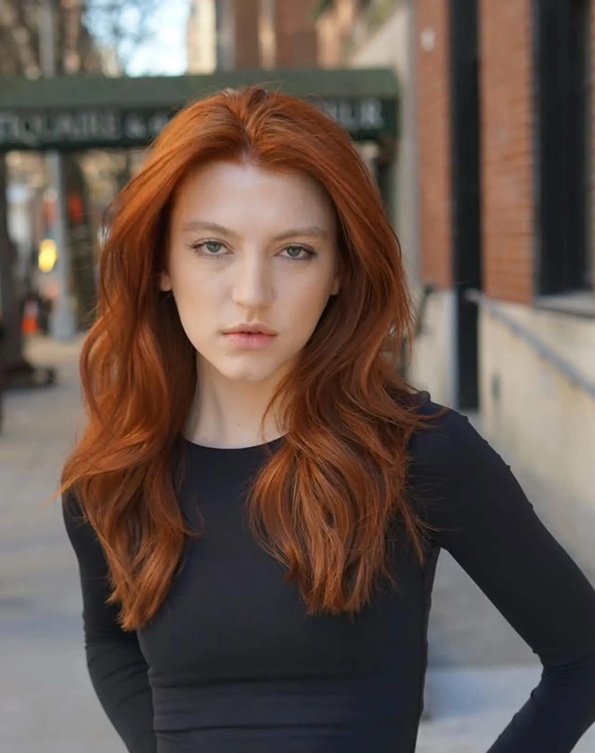 Long, wavy hairstyle with soft layers and a vibrant copper red color. 1